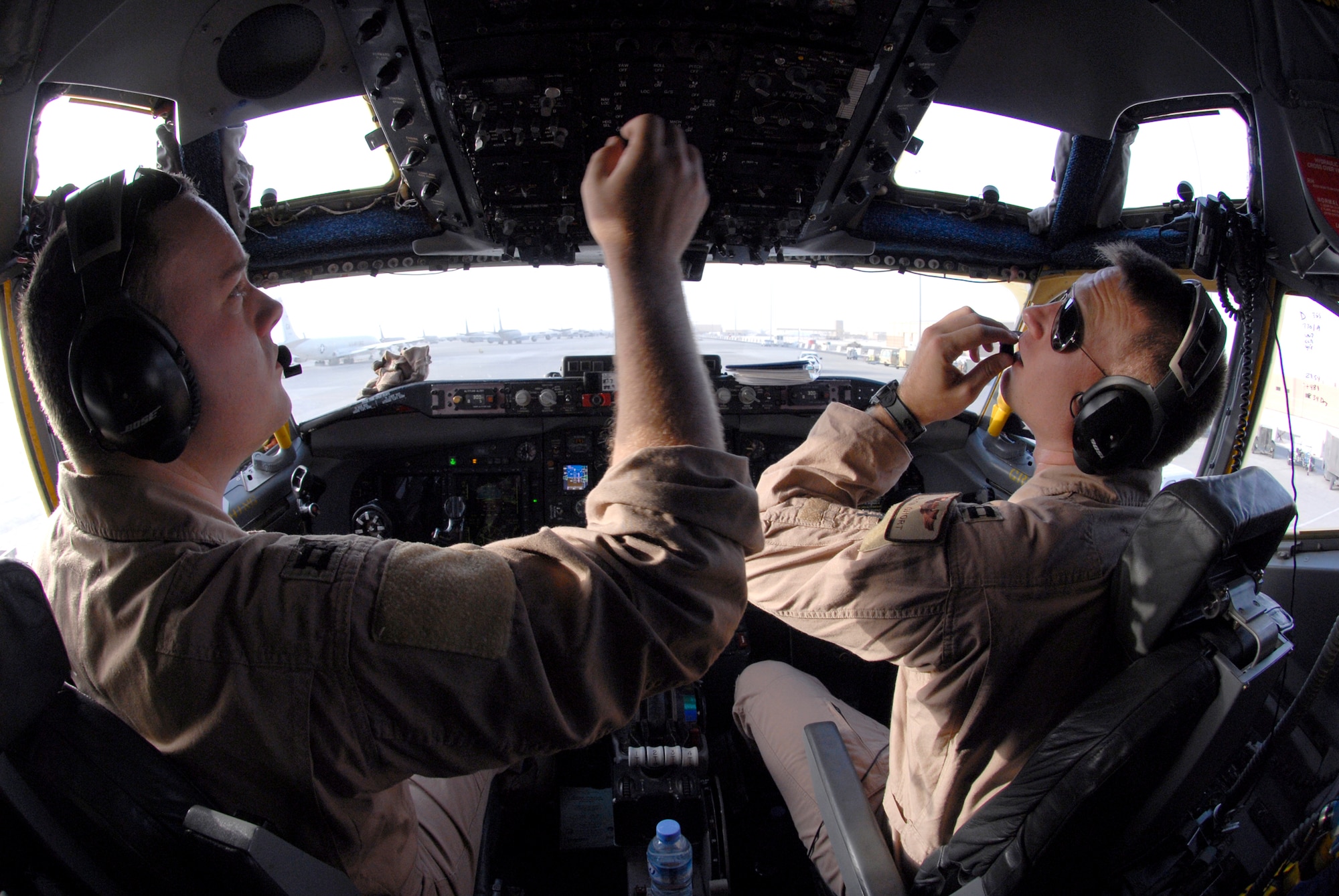 Captain Keegan McConaughey, a 763rd Expeditionary Reconnaissance Squadron (ERS) Aircraft Commander, and Captain Allen Short, 763rd ERS Co-Pilot, perform their pre-flight checks in the cockpit of an RC-135 Rivet Joint aircraft, June 24, 2009, at an undisclosed location in southwest Asia.  The Airmen on board collect intelligence and analyze data for mission support in the U.S. Central Command's area of responsibility.  Capt. McConaughey hails from Houlton, Wis., Capt. Short hails from Chino Valley, Calif.  Both are deployed from Offutt Air Force Base, Neb. in support of Operations Iraqi and Enduring Freedom and Combined Joint Task Force - Horn of Africa.  (U.S. Air Force photo/Senior Airman Andrew Satran/released)