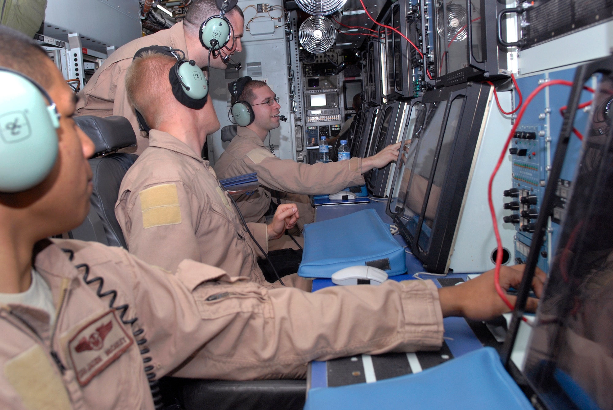 Senior Airman Chris Strawn, a 763rd Expeditionary Reconnaissance Squadron (ERS) airborne analyst, Staff Sgt. Thomas Hopewell, a 763rd ERS airborne systems engineer 4, Staff Sgt. Dan Klenc, a 763rd ERS data link operator, and Senior Airman Jason McCauley, a 763rd ERS airborne systems engineer 2, go over their pre-flight equipment function checks in an RC-135 Rivet Joint aircraft, June 24, 2009, at an undisclosed location in Southwest Asia.  The Airmen on board collect intelligence and analyze data for mission support in the U.S. Central Command's area of responsibility.  Airman Strawn hails from Agoura, Calif.  Sergeant Hopewell hails from Salem, Ore.    Sergeant Klenc is from St. Louis, Mo.  Airman McCauley hails from Pittsburgh, Pa.  All are deployed from Offutt Air Force Base, Neb. in support of Operations Iraqi and Enduring Freedom and Combined Joint Task Force - Horn of Africa.  (U.S. Air Force photo/Senior Airman Andrew Satran/released)