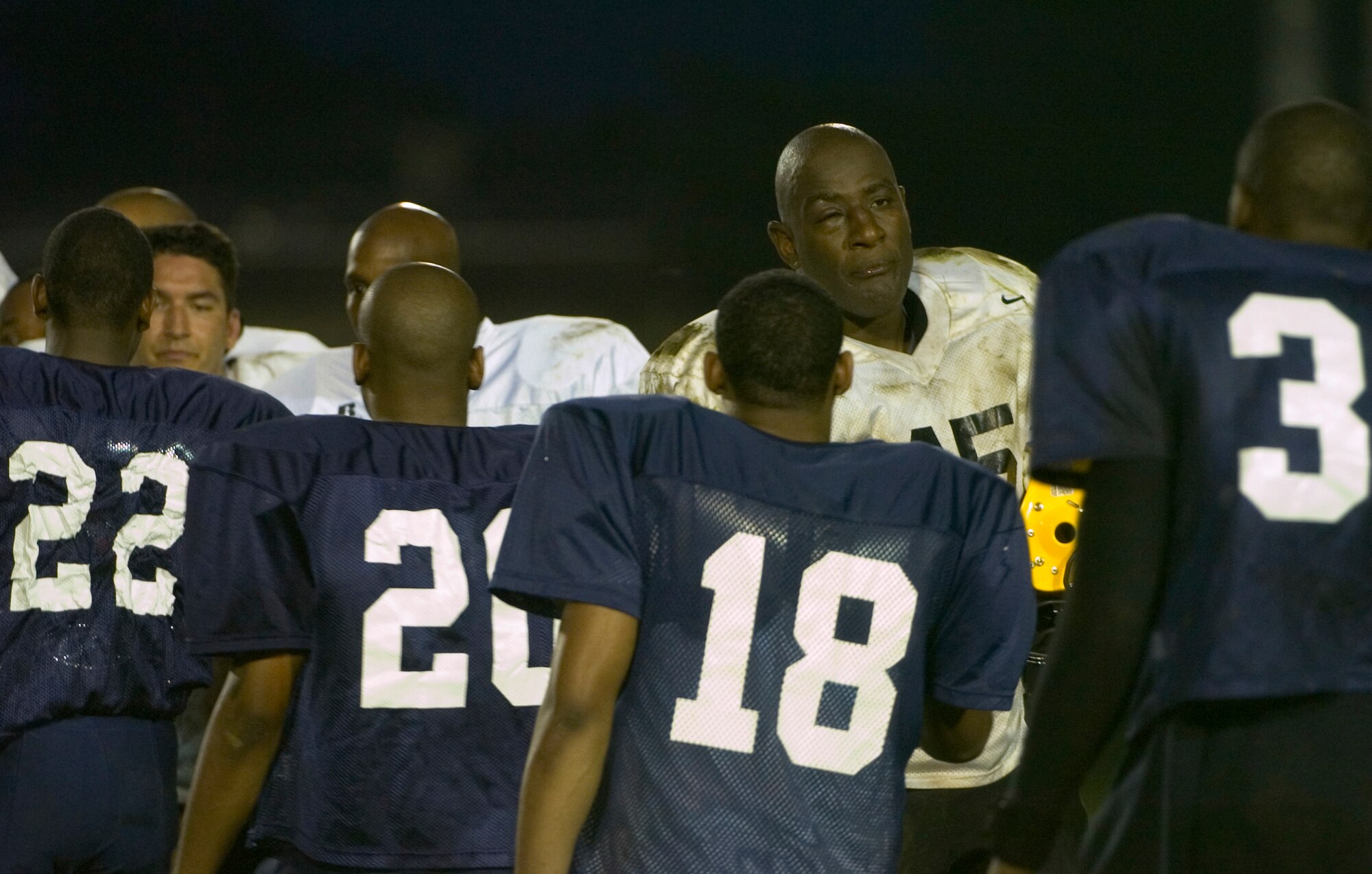 YOKOTA AIR BASE, Japan -- Torii Station Wolfpack player-coach Darell Keith (center, white jersey) congratulates the Yokota Warriors June 27 following Yokota's 12-6 win over the Wolfpack in U.S. Forces Japan-American Football League action at Bonk Field. Yokota improved to 2-3 on the season on the strength of a defense that has allowed only 18 points in the last two games. (U.S. Air Force photo/Master Sgt. Matt Summers)  