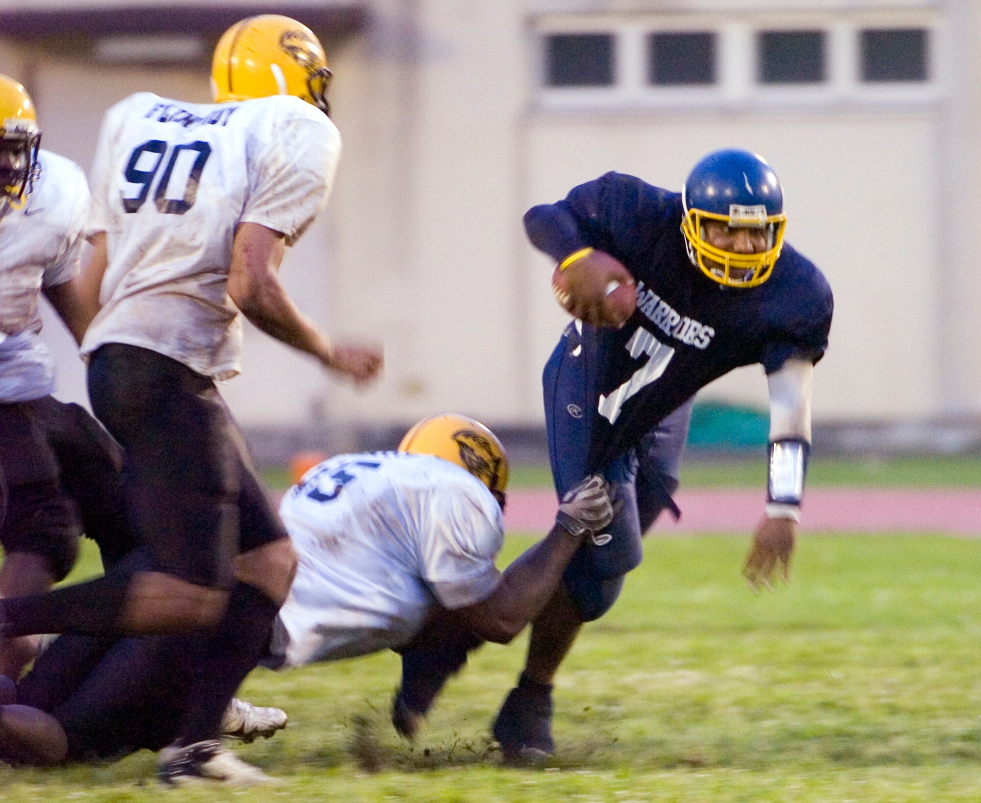 YOKOTA AIR BASE, Japan -- Warriors' quarterback Ryan Jones tries to turn the corner against a Torii Station defender June 27 during Yokota's 12-6 win over the Wolfpack in U.S. Forces Japan-American Football League action at Bonk Field. Yokota improved to 2-3 on the season on the strength of a defense that has allowed only 18 points in the last two games. (U.S. Air Force photo/Master Sgt. Matt Summers)  