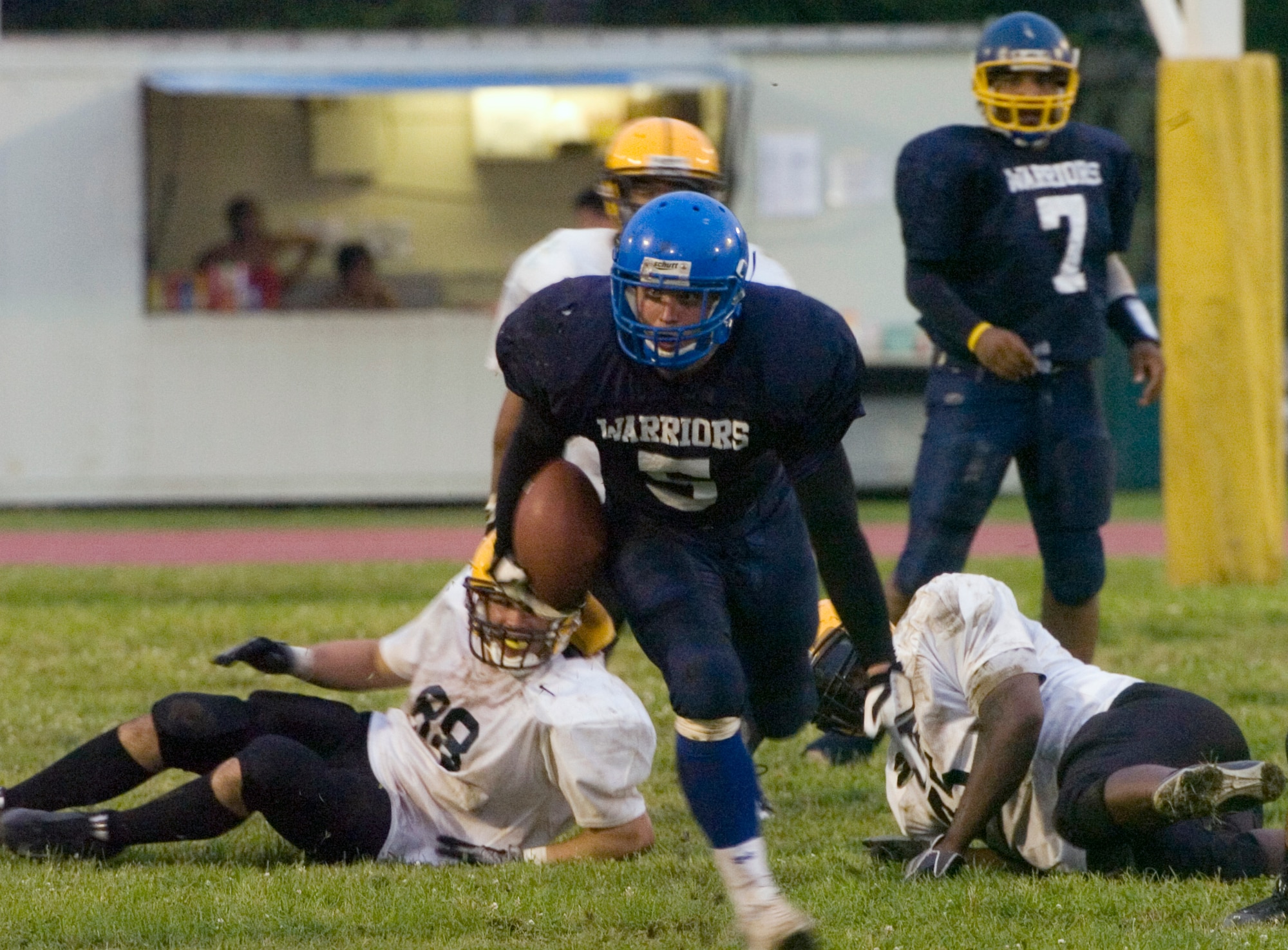 YOKOTA AIR BASE, Japan -- Warriors' running back Kevin Fortin slices through the Torii Station Wolfpack defense enroute to an 80-yard touchdown scamper June 27 during Yokota's 12-6 win in U.S. Forces Japan-American Football League action at Bonk Field. Fortin also had a 5-yard TD plunge to help Yokota improve to 2-3 on the season. (U.S. Air Force photo/Master Sgt. Matt Summers)  
