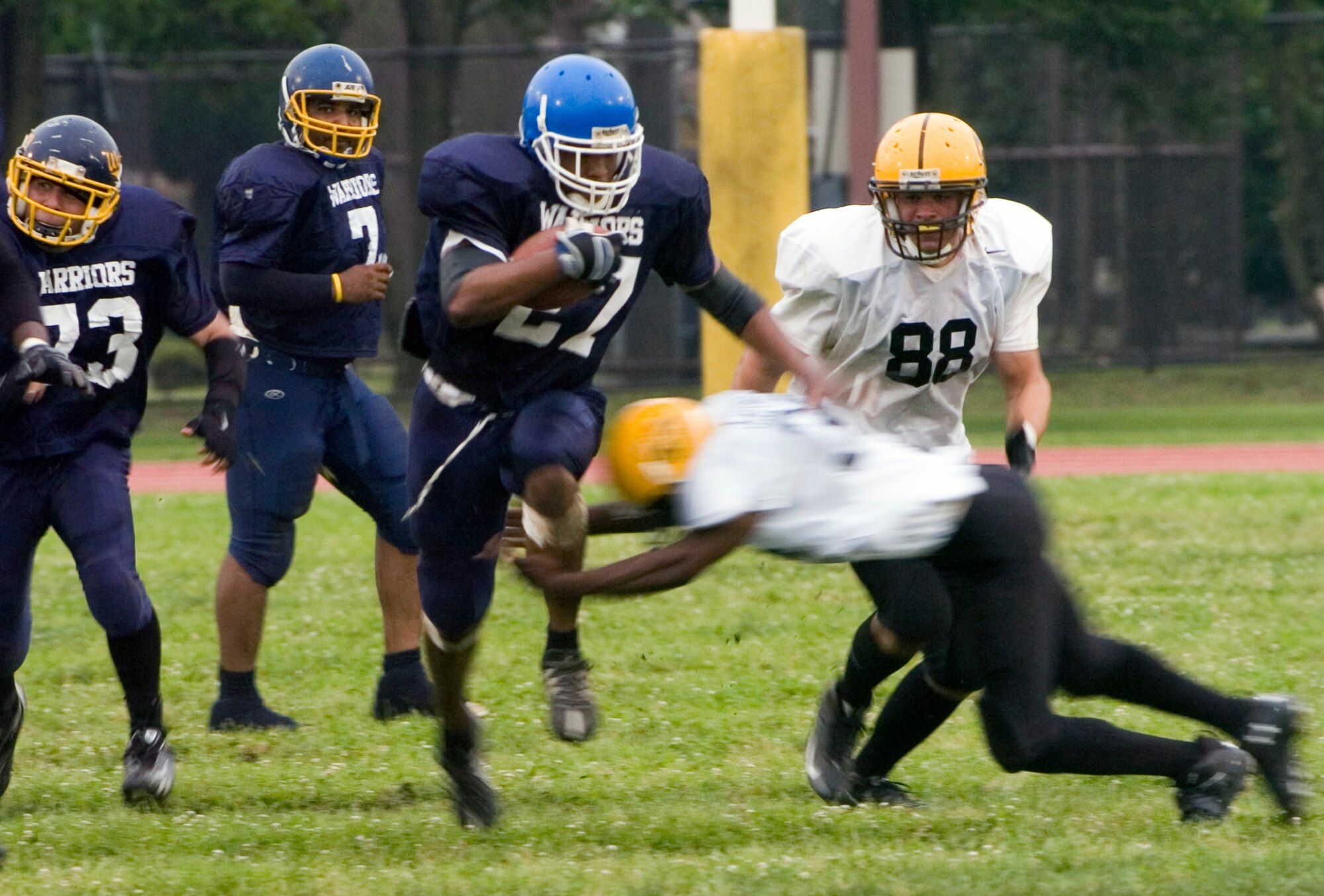 YOKOTA AIR BASE, Japan -- Warriors' running back Dominique Carvin high steps it through the Torii Station Wolfpack defense June 27 in Yokota's 12-6 win over the Wolfpack in U.S. Forces Japan-American Football League action at Bonk Field. The Warriors improved to 2-3 on the season and moved into second place in the league's northern division. (U.S. Air Force photo/Master Sgt. Matt Summers)  