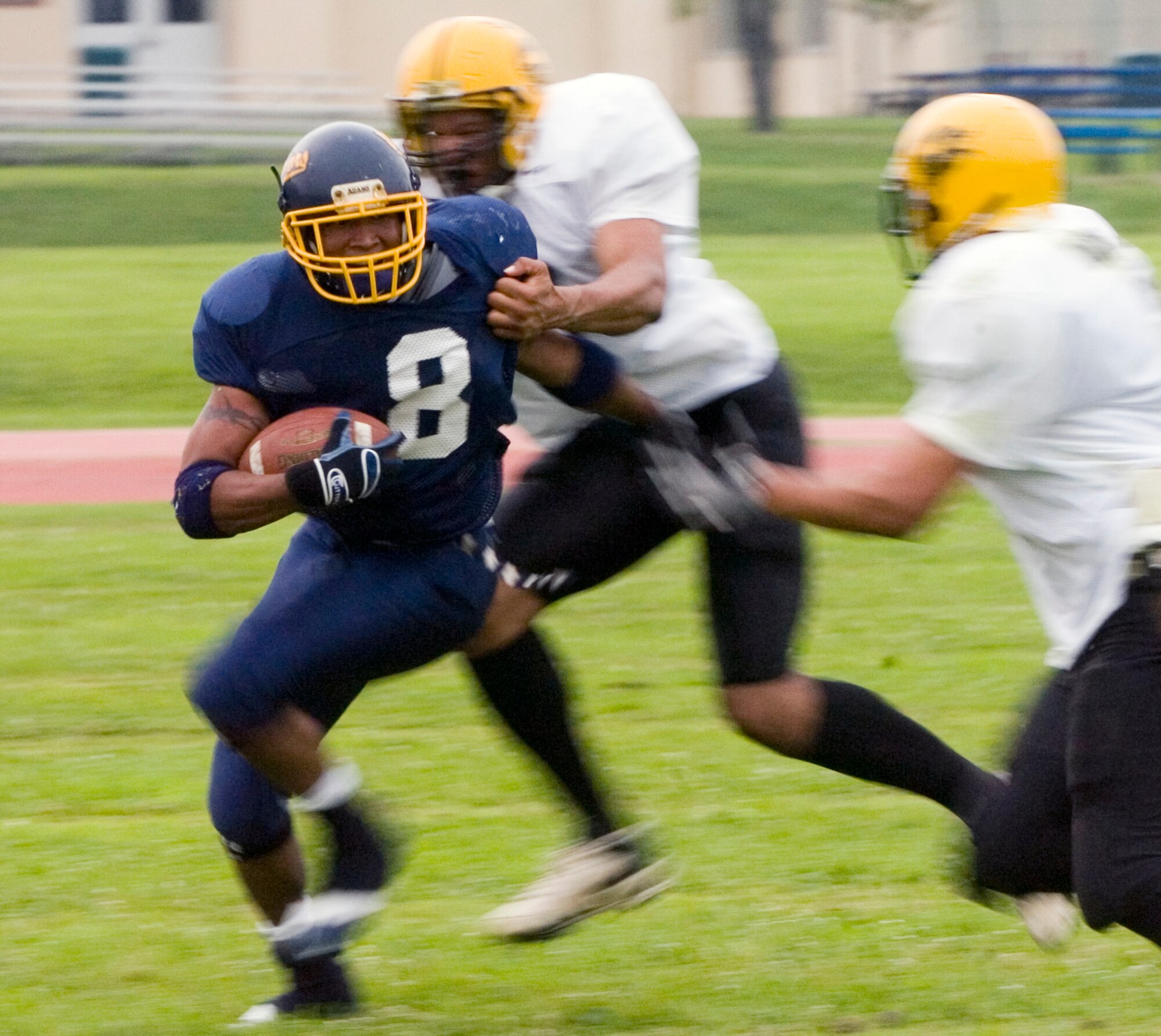 YOKOTA AIR BASE, Japan -- Warriors' running back Michael Mathis gets caught from behind June 27 during Yokota's 12-6 win over the Torii Station Wolfpack in U.S. Forces Japan-American Football League action at Bonk Field. Yokota improved to 2-3 on the season and second place league's northern division. (U.S. Air Force photo/Master Sgt. Matt Summers)  