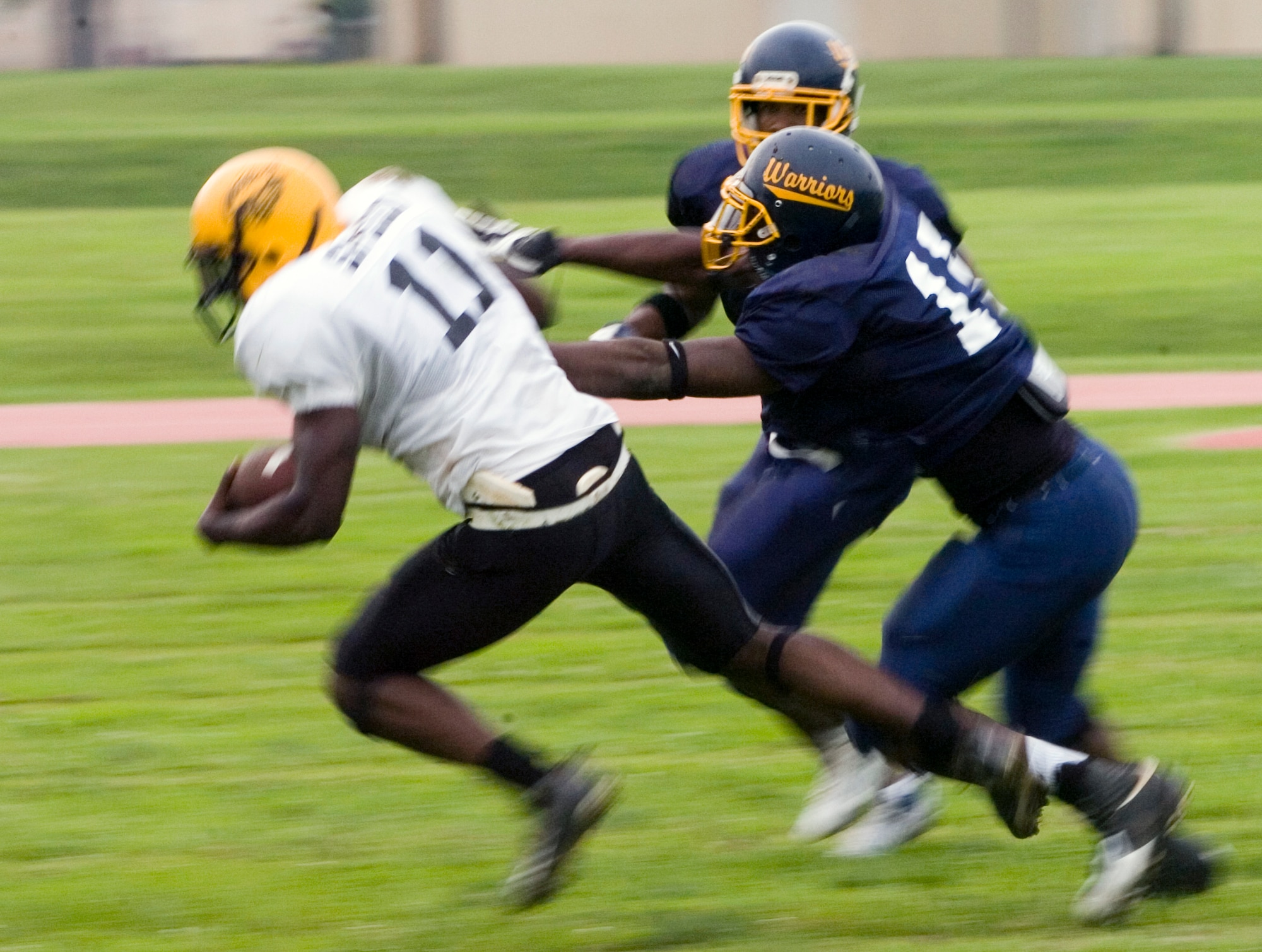 YOKOTA AIR BASE, Japan -- Warriors' linebacker Donald White chases down the Torii Station quarterback June 27 during Yokota's 12-6 win over the Torii Station Wolfpack in U.S. Forces Japan-American Football League action at Bonk Field. Yokota improved to 2-3 on the season on the strength of a defense that has allowed only 18 points in the last two games. (U.S. Air Force photo/Master Sgt. Matt Summers)  