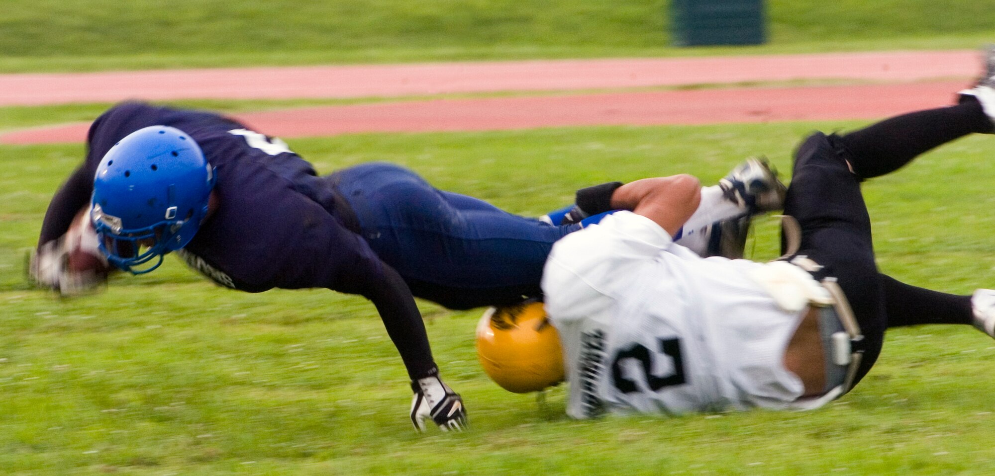 YOKOTA AIR BASE, Japan -- Warriors' running back Kevin Fortin fights for every yard June 27 during Yokota's 12-6 win over the Torii Station Wolfpack in U.S. Forces Japan-American Football League action at Bonk Field. Fortin scored two touchdowns, a 5-yard run and an 80-yard scamper to help Yokota improve to 2-3 on the season. (U.S. Air Force photo/Master Sgt. Matt Summers)  