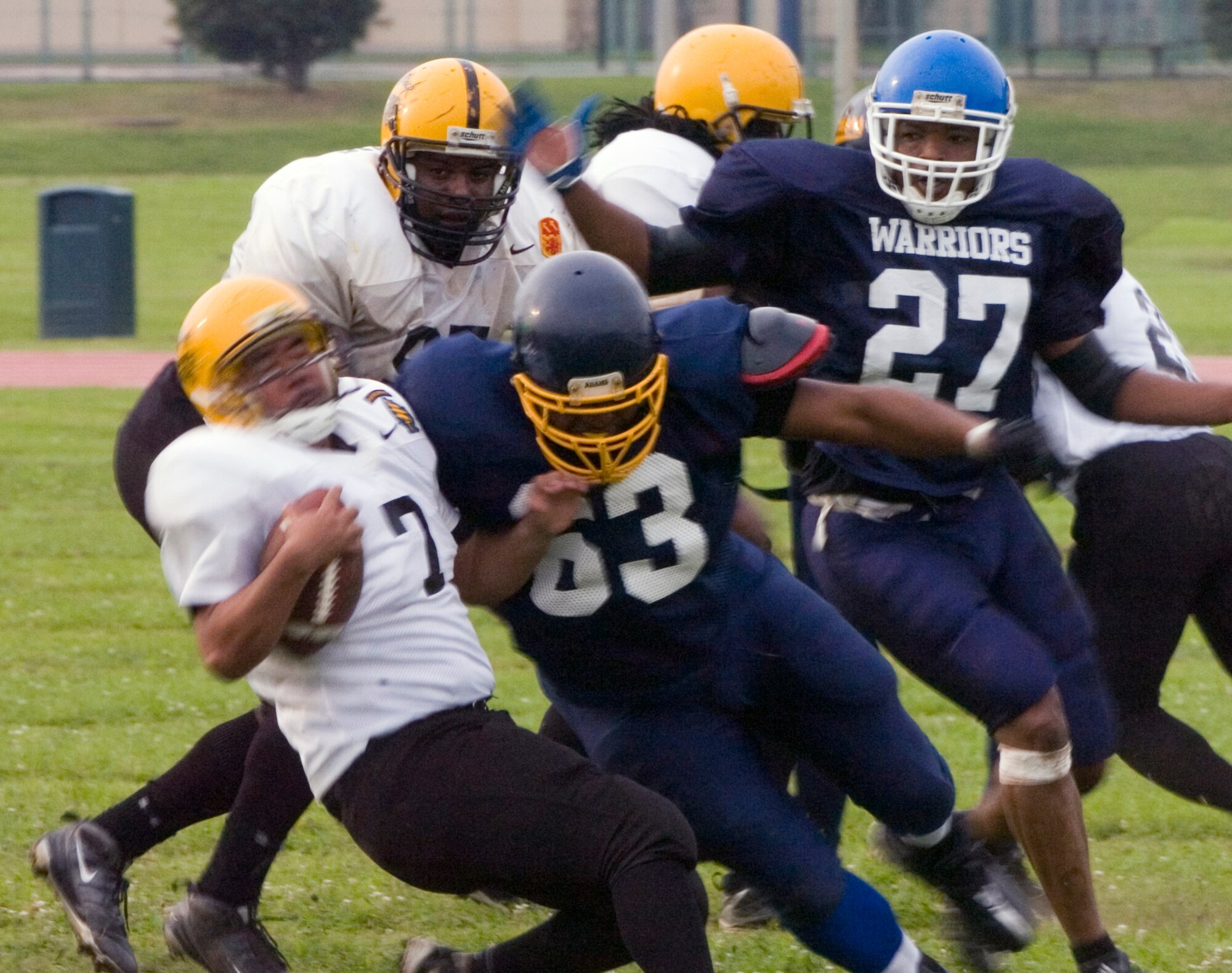 YOKOTA AIR BASE, Japan -- Warriors' defensive tackle Davaines Brown destroys his blocker and drops the Torii Station quarterback for a loss June 27 during Yokota's 12-6 win over the Torii Station Wolfpack in U.S. Forces Japan-American Football League action at Bonk Field. Yokota improved to 2-3 on the season on the strength of a defense that has allowed only 18 points in the last two games. (U.S. Air Force photo/Master Sgt. Matt Summers)  