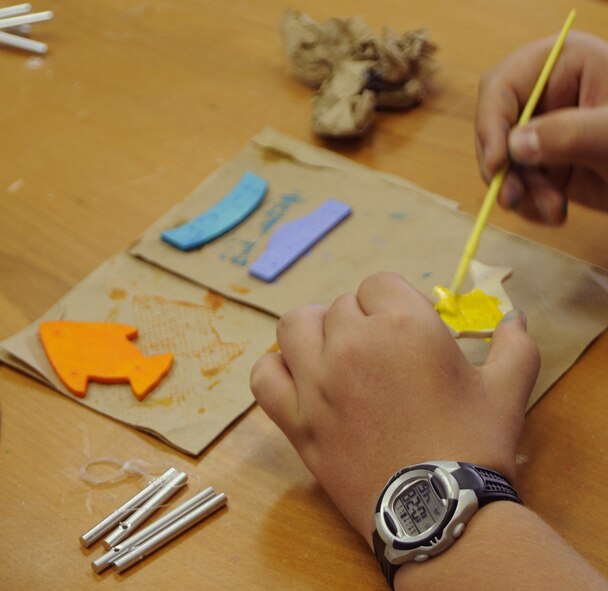 Ben Kaya, son of Elizabeth Kaya, 39th Communications Squadron, paints his last shape for his handmade wind chime Thursday, June 25, 2009 during the Youth Programs art camp at Incirlik Air Base, Turkey. The camp, which ran the entire week, is one of several camps and recreation trips available for children during their summer. For more information about activities call YP at 676-6670. (U.S. Air Force photo/Airman 1st Class Amber Russell)