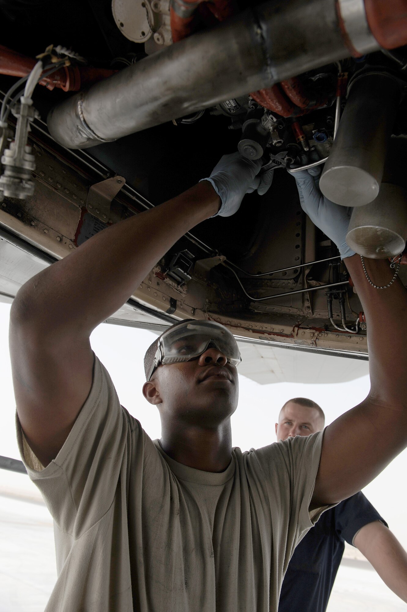 SOUTHWEST ASIA - Airman 1st Class Justin Lassiter, 380th Expeditionary Aircraft Maintenance Squadron, Extender maintenance flight, works on the auxilary power unit (APU) fuel control on a KC-10 Extender, June 10 at an undisclosed location in Southwest Asia. The APU provides the aircraft with electrical and pneumatic power. (U.S. Air Force photo by Senior Airman Brian J. Ellis) (Released)