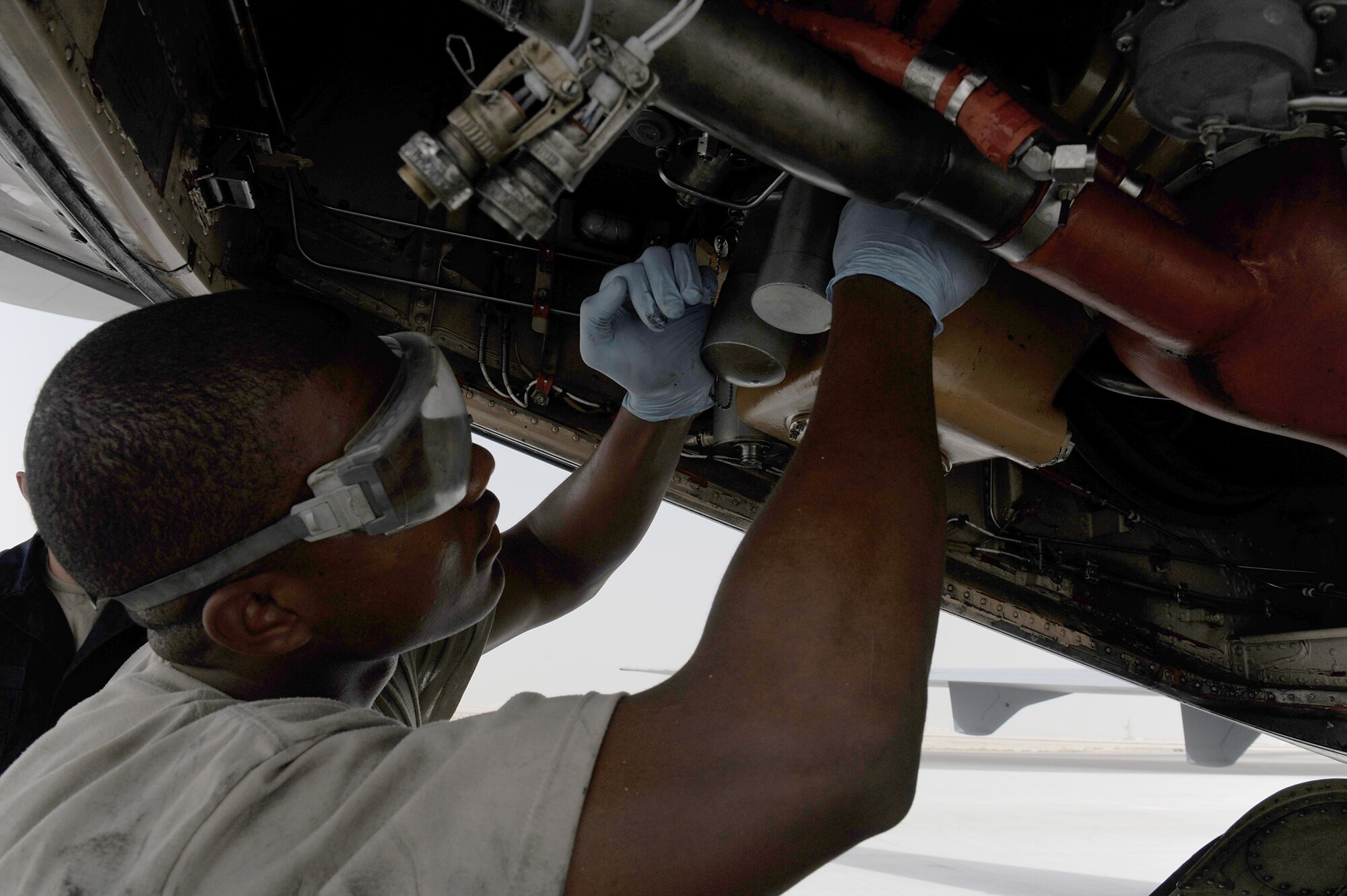 SOUTHWEST ASIA - Airman 1st Class Justin Lassiter, 380th Expeditionary Aircraft Maintenance Squadron, Extender maintenance flight, works on the auxilary power unit (APU) fuel control on a KC-10 Extender, June 10 at an undisclosed location in Southwest Asia. The APU provides the aircraft with electrical and pneumatic power. (U.S. Air Force photo by Senior Airman Brian J. Ellis) (Released)