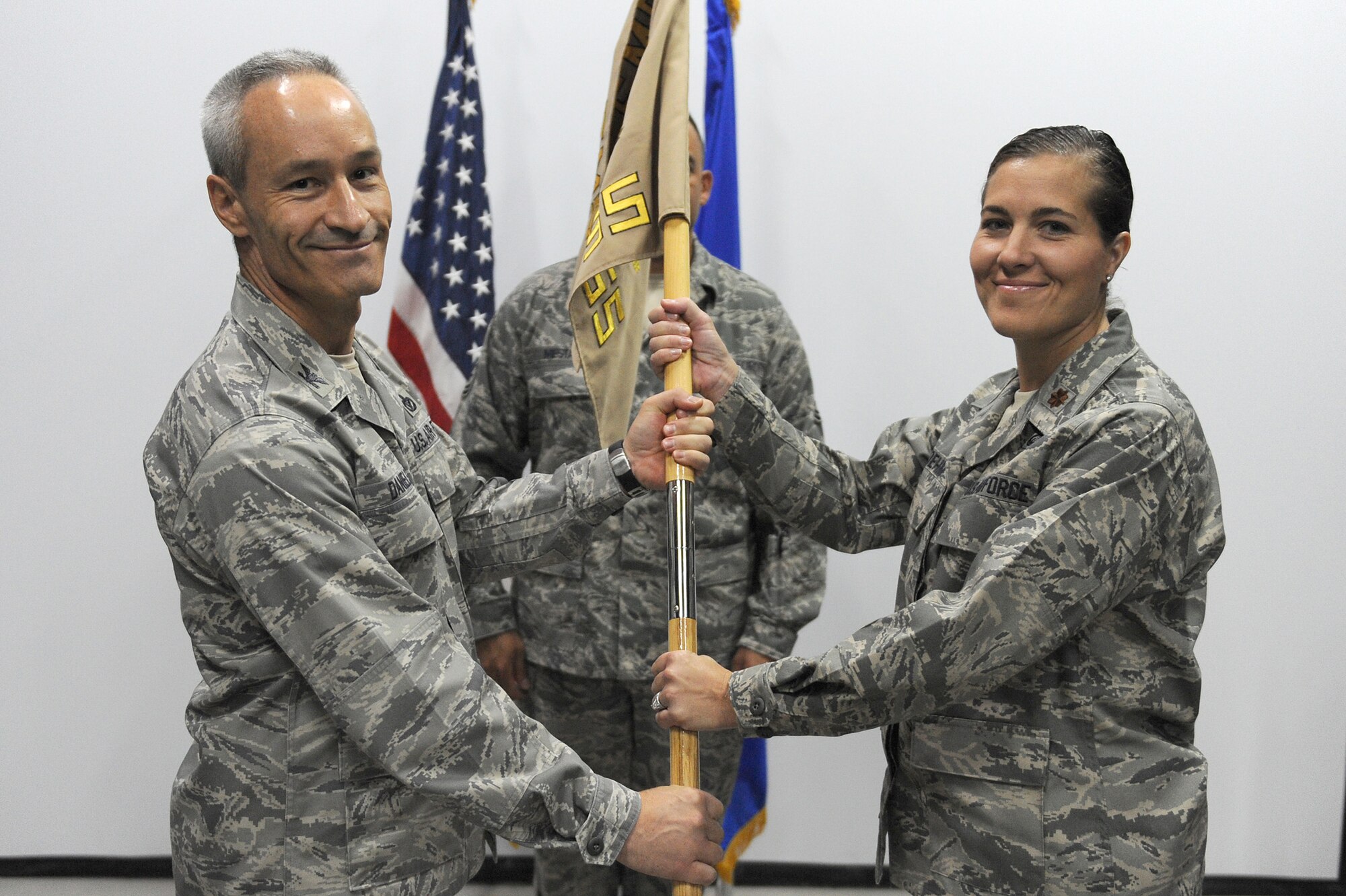 SOUTHWEST ASIA - Maj. Kimberly Boehm takes command of the 380th Expeditionary Force Support Squadron as she receives the squadron guidon from Col. Darren Daniels, 380th Expeditionary Mission Support Group, commander, June 27 at an undisclosed location in Southwest Asia. Major Boehm comes from Vandenberg AFB, Calif. to lead the Airmen of the 380th EFSS. (U.S. Air Force photo by Senior Airman Brian J. Ellis) (Released)