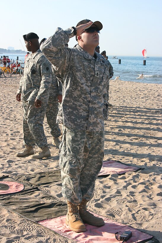 U.S. Army Staff Sgt. Jeffrey Ciancaglini salutes the American flag as members of the 82nd Airborne Division’s All-American Freefall Team jump in front of about 10,000 spectators at the Chicago 2016 Olympic Day celebration on North Avenue Beach in Chicago, June 23, 2009. Ciancaglini is a jumpmaster and drop zone safety officer at the U.S. Army Advanced Airborne School on Fort Bragg, N.C.