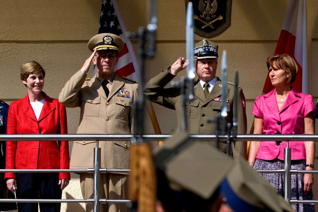 U.S. Navy Adm. Mike Mullen, chairman of the Joint Chiefs of Staff, and his wife Deborah, left, are welcomed to Warsaw, Poland by Gen. Franciszek Gagor, chief of the General Staff of the Polish Armed Forces, and his wife Lucy with a full-honors ceremony, June 29, 2009. 