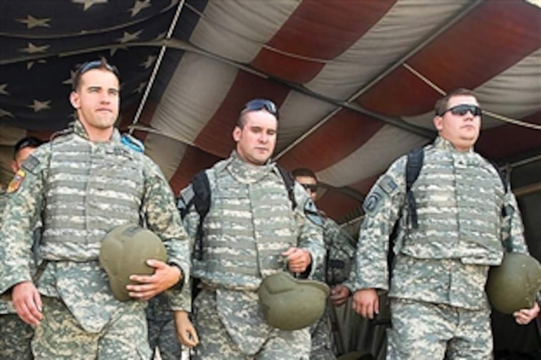 Left to right; U.S. Army Sgt. Robert Brown, Staff. Sgt., retired, Bradley Gruetzner and Sgt.  Christopher A. Burrell, soldiers wounded in combat while deployed to Iraq, walk through “Hero’s Highway” at Air Force Theater Hospital before returning to Camp Victory after a visit to Joint Base Balad, Iraq, June 25, 2009. Brown, Gruetzner, Burrell and four other soldiers had the opportunity to return to Iraq and to visit the places they once served.