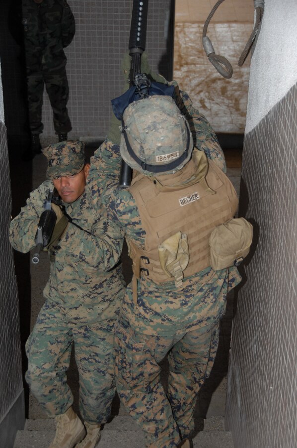 Cpl. Solomon Brown and Lance Cpl. Andrew Becher from the 2nd Marine Expeditionary Forces (II MEF) demonstrate different techniques for clearing stairwells.  II MEF is participating in U.S. Marine Corps Forces, South multinational combined exercise Southern Exchange 2009 in Rio de Janeiro from July 13-31. (U.S Army Photo by Spc. Corey Idleburg/Release)