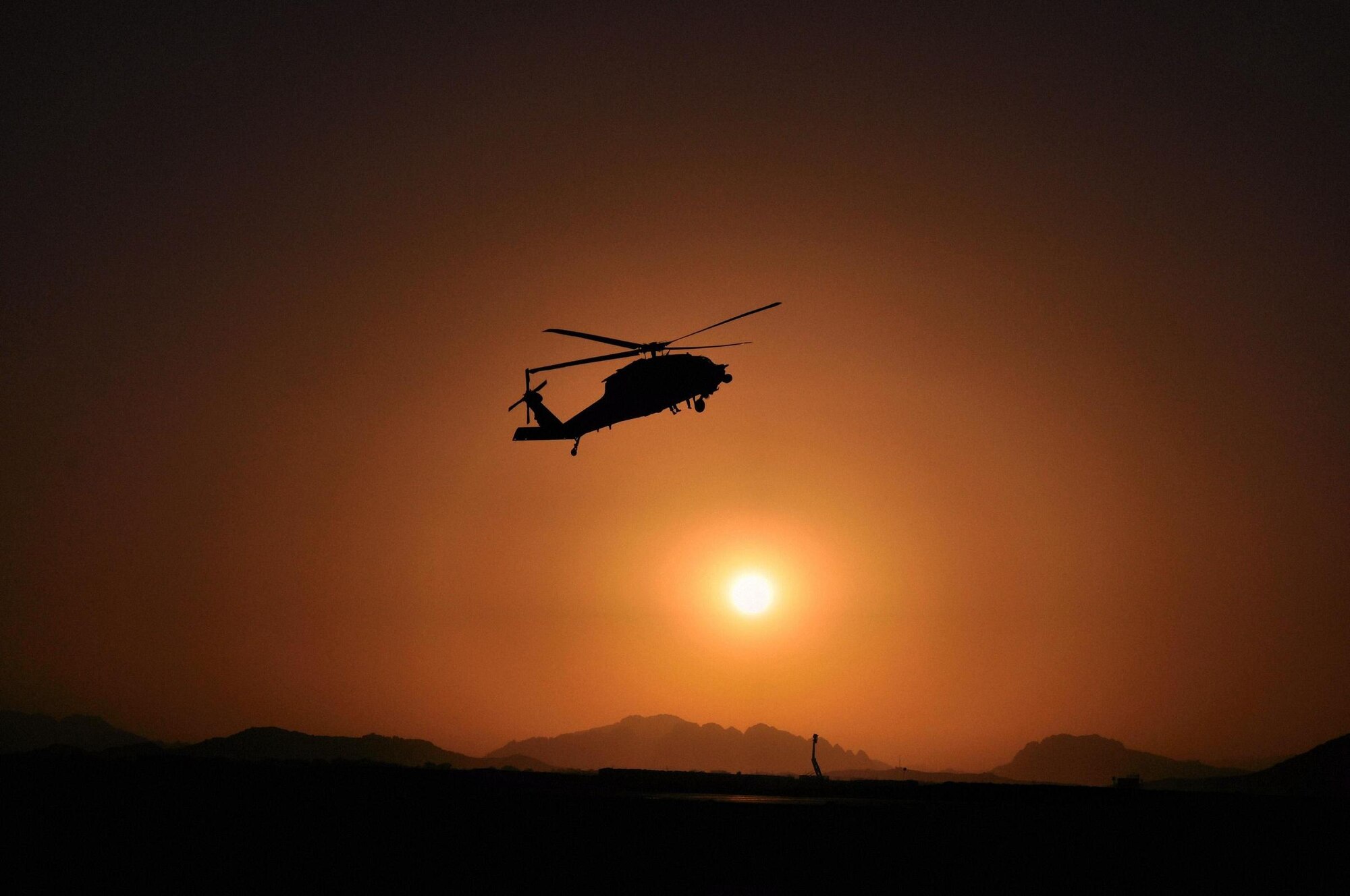 A 129th Rescue Wing-based aircrew flies an HH-60G Pave Hawk rescue helicopter over Kandahar Airfield, Afghanistan, June 6. More than 65 Airmen deployed to Afghanistan in May for two to four months to provide combat search and rescue support for Operation Enduring Freedom. (Photo courtesy of Guillermo Rivera) 