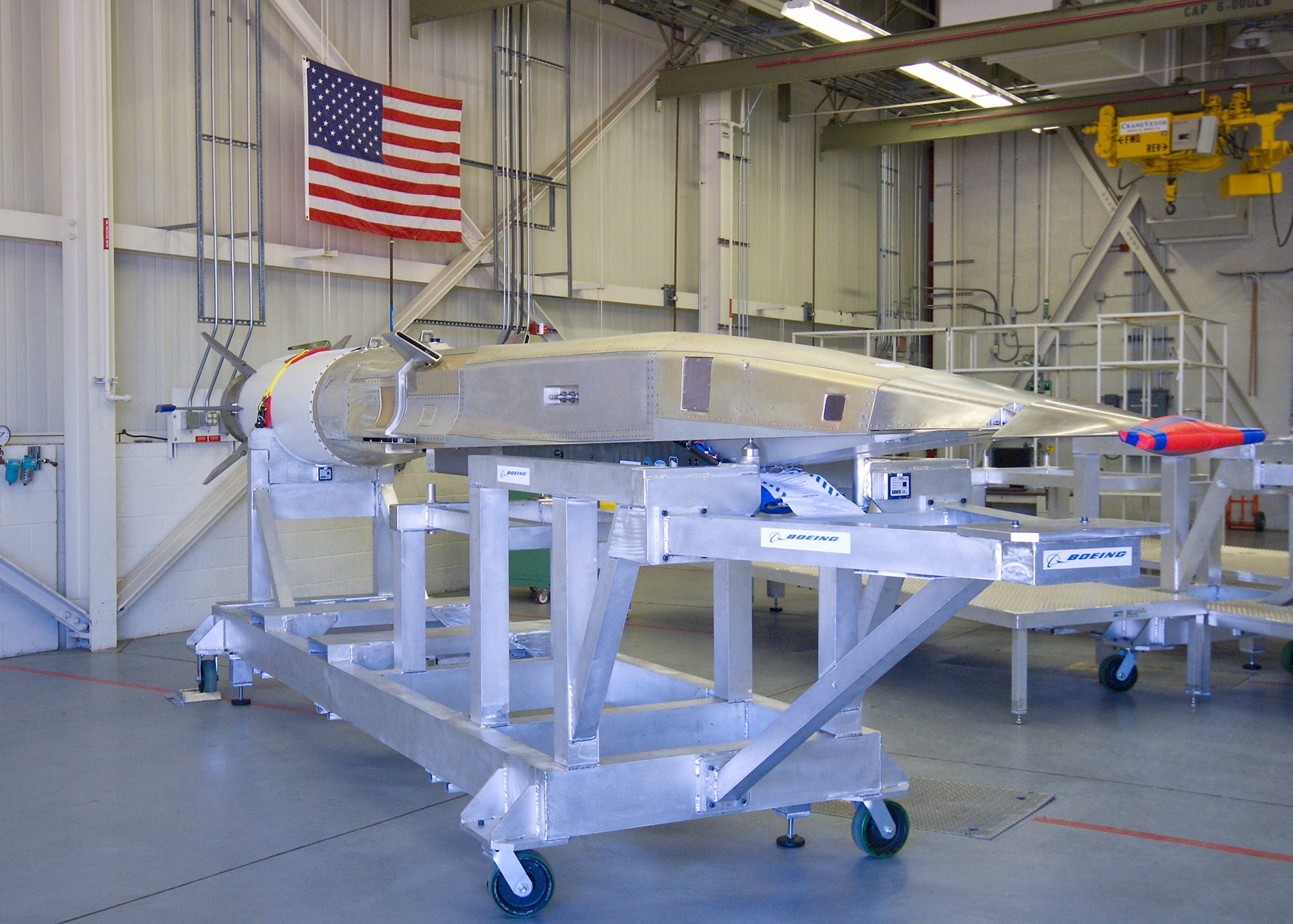 The first X-51A Scramjet Engine Demonstrator WaveRider vehicle arrived at Edwards Integrated Maintenance Facility, Building 710 June 25. The aircraft will begin ground tests July 6. 

Assembly was completed last month at Boeing's High Desert Assembly, Integration and Test facility at Plant 42 in Palmdale, Calif. This aircraft is the first of four Static Test Vehicles, which will be used for familiarization training and an Upload and Download Test. 

The X-51A SED program is intended to demonstrate air breathing hypersonic propulsion using a Pratt & Whitney Rocket dyne scramjet.  The 25-foot long, 4,000 pound vehicle will be carried aloft on a B-52H Stratofortress and released in the Point Mugu Sea Range.  A solid rocket booster will propel it to nearly Mach 5, where the scramjet will take over and continue to propel the X-51A for another 4 minutes to nearly Mach 6.  The X-51A Program Office at the Air Force Research Laboratory, Propulsion Directorate, Wright-Patterson AFB designated the Hypersonic Combined Task Force at the AFRL site at Edwards.

Following the Upload and Download Test, ground tests will continue through the summer and the X-51A is scheduled to perform additional testing through winter 2010. (Air Force photo/Mike Cassidy)
