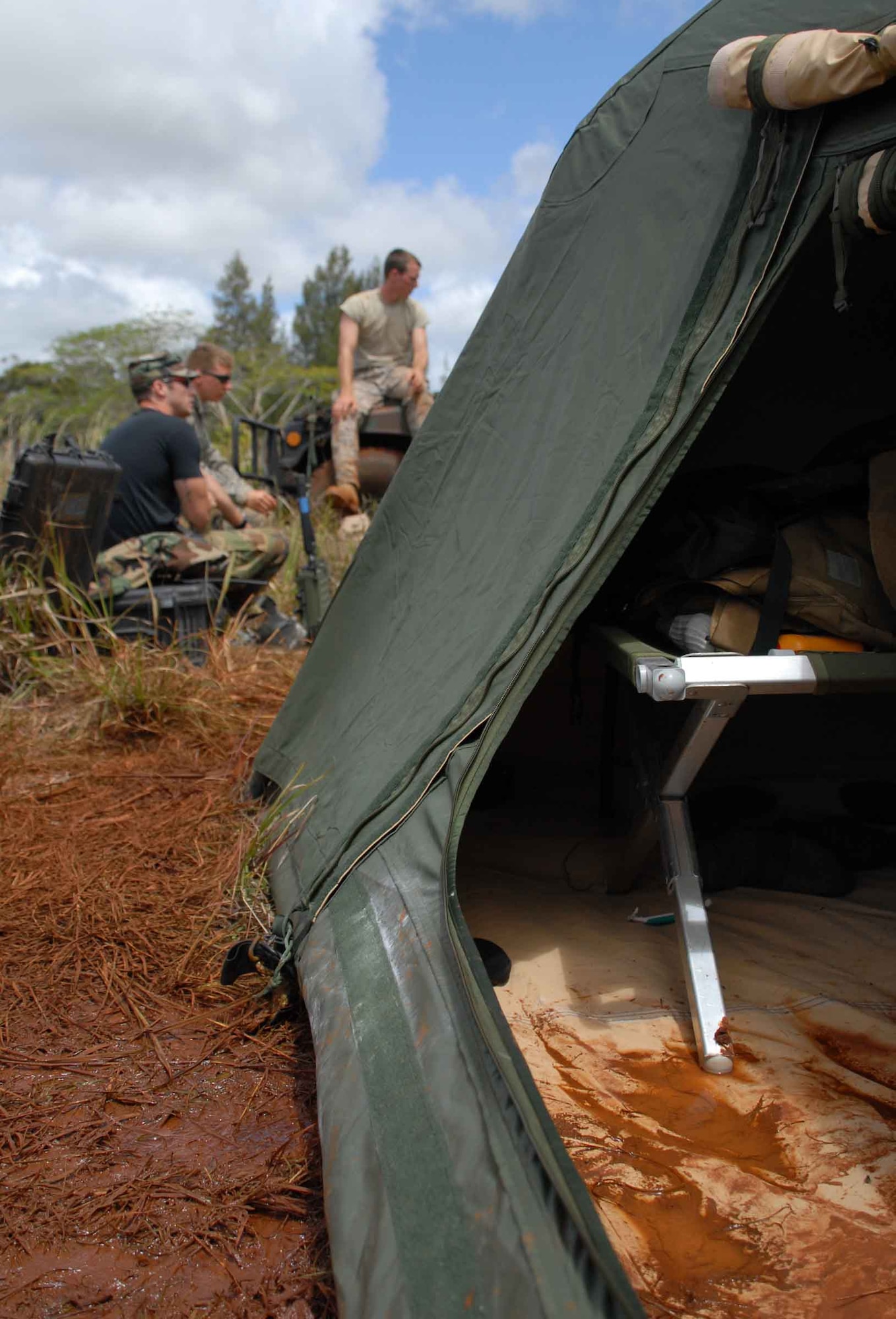 WHEELER ARMY AIR FIELD, Hawaii -- Hickam Air Force Base Tactical Air Control Party Airmen trained with 25th Infantry Division Headquarters, Headquarters Company 114th Infantry Soldiers at Wheeler Army Air Field's East Range near Hickam AFB June 23-26. Training included combat lifesaver skills, convoys, air assault egression, and improvised explosive device reaction. Having spent so much time in the muck, these Hickam AFB TACPs are now prepared for the rain, cold and mud of an upcoming winter deployment to Afghanistan. (U.S. Air Force photo/Senior Airman Carolyn Viss)