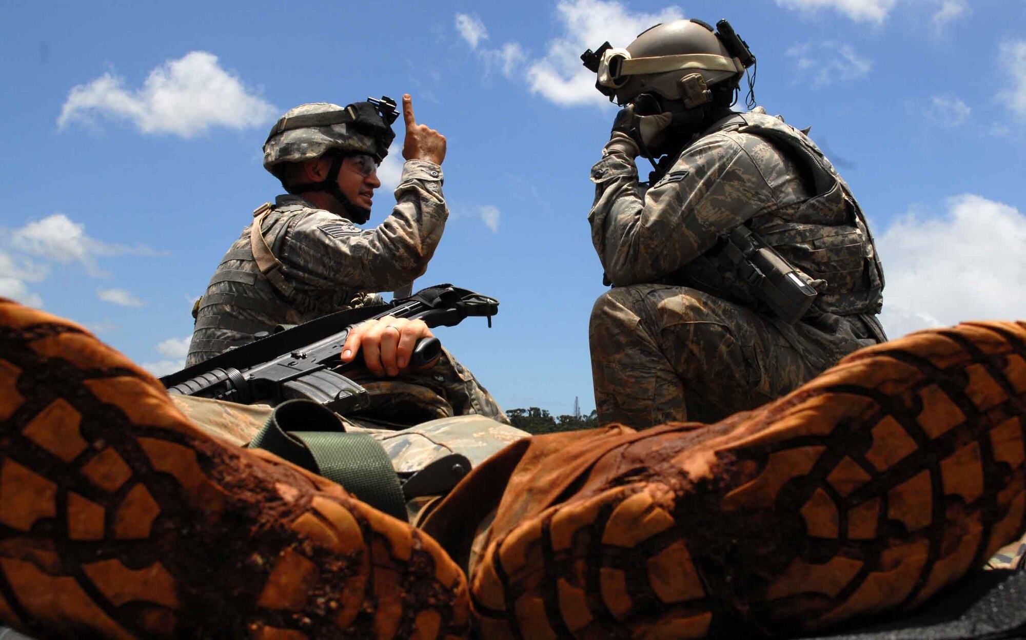 WHEELER ARMY AIR FIELD, Hawaii -- Tech. Sgt. Alejandro Castillo indicates to Airman 1st Class Chris Tamblyn, 25th Air Support Operations Squadron Tactical Air Control Party, to prepare to load a casualty on a CH-47 Chinook for aeromedical evacuation during field training June 24. Radio Operators, Maintainers and Drivers camped out for four days to sharpen proficiencies necessary for upgrade training to become combat mission-ready Joint Terminal Attack Controllers. Because they're training now, they'll have a better idea of what to expect when they get to Afghanistan with an Army unit. (U.S. Air Force photo/Senior Airman Carolyn Viss)