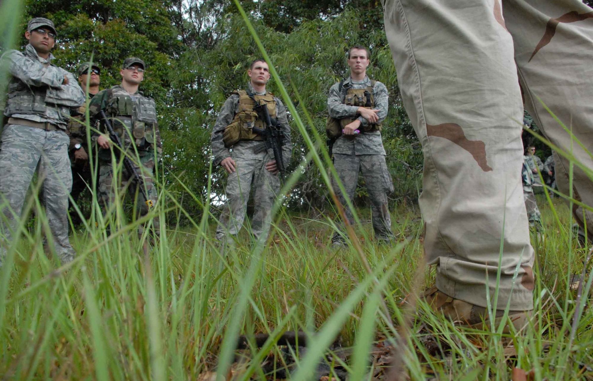 WHEELER ARMY AIR FIELD, Hawaii -- Tactical Air Control Party Airmen trained with 25th Infantry Division Headquarters, Headquarters Company 114th Infantry Soldiers at Wheeler Army Air Field's East Range near Hickam AFB June 23-26. The 25th Air Support Operations Squadron partnered with the Army to glean information based on experiences the Soldiers have had in Iraq and Afghanistan recently to prepare for an upcoming 25th ASOS deployment. The training helped sharpen proficiencies necessary for Radio Operators, Maintainers and Drivers to become combat mission-ready Joint Terminal Attack Controllers. (U.S. Air Force photo/Senior Airman Carolyn Viss)