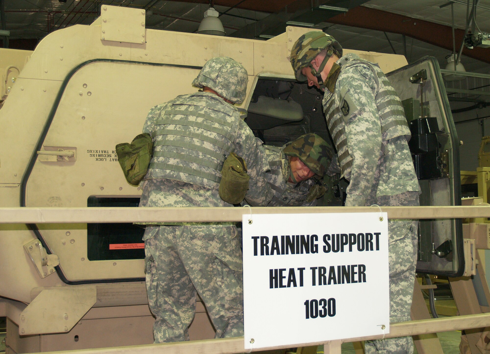 FORT MCCOY, Wis. - (Left) Army Private 1st Class George Pavlak, of Aurora, Mo., and Company A of 935th Aviation Support Battalion, and (right) Spc. Joshua Deaton, of Vienna, Mo., and Detachment 3 of Company B of 935th battalion, help Sgt. 1st Class Dirk Hodkins, of Warrensburg, Mo., and Detachment 3 of Company B of 935th battalion, from the 180-degree humvee rollover. (Photo by Rachel Knight/Missouri National Guard)