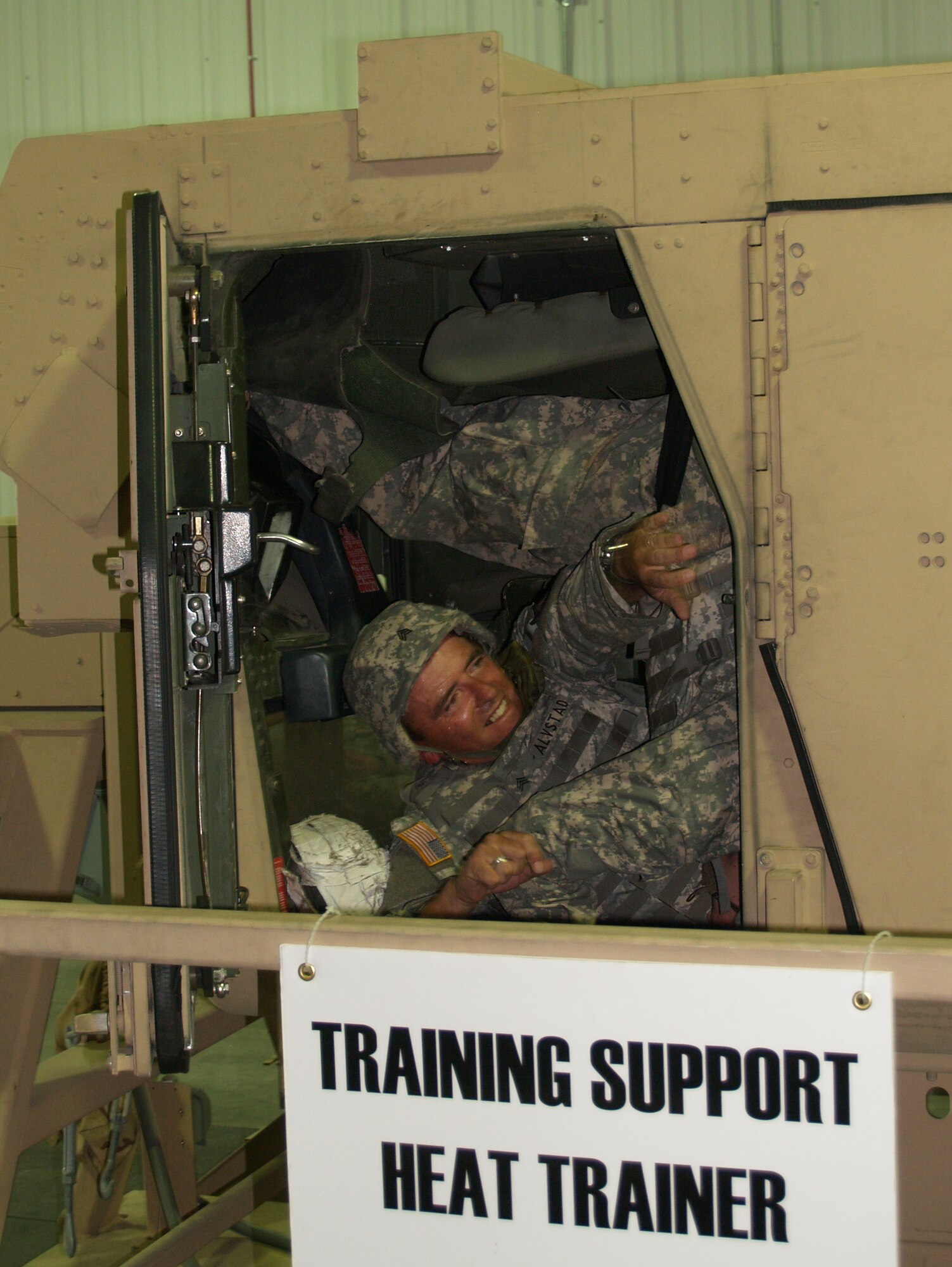 FORT MCCOY, Wis. - Army Sgt. David Alvstad, of Aurora, Mo., and member of Company A, opens the only opening door on the humvee and crawls through the opening. He then extracted the front passenger who was a causality when the simulated improvised explosive device hit their humvee. (Photo by Rachel Knight/Missouri National Guard)