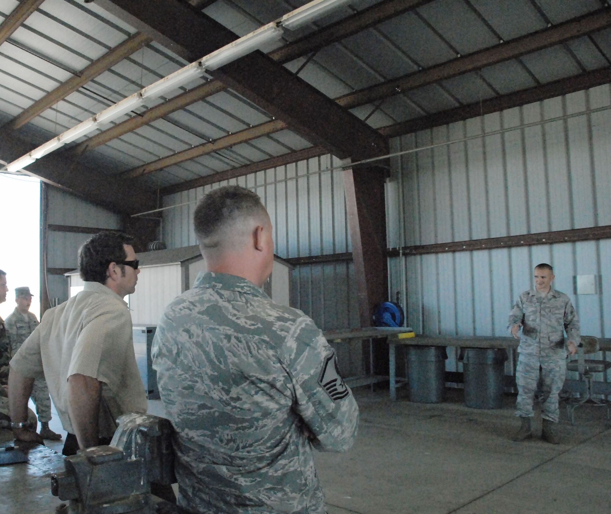 Staff Sgt. Nathan Scruggs explains how the members of the 9th Munitions Squadron handle munitons for training classes June 23 at Beale Air Force Base, Calif. The squadron took part in a value stream mapping event to improve the process they use for their Combat Ammuntion Planning and Production courses. (U.S. Air Force photo/Tech. Sgt. Luke Johnson)