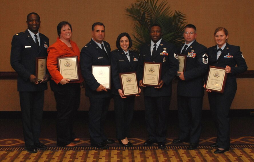 NIAGARA FALLS AIR RESERVE STATION, N.Y. - From left:  Maj. Patrick Campbell, Mrs. Beth Greaser, Col. Terry Lawrence accepting for Lt.Col. Samuel Bellia, 1st Lt. Gina Pizziconi-Cupples, Tech. Sgt Marvin Holmes, Senior Master Sgt. Roger Rozon and Tech. Sgt. Victorine Cleaveland, all members of the 914th Airlift Wing, are recipients of the Excellence in Government Awards given May 5, 2009.  (U.S. Air Force photo by Senior Airman Stephanie Clark)