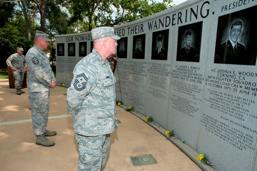 EGLIN AIR FORCE BASE, Fla. -- On the 13th anniversary of terrorist bombing of Khobar Towers bombing, members of the 33rd Fighter Wing gathered June 25 to honor the lives of fallen comrades. Joined with their commander and visiting surviving family members, they laid flowers and a wreath during a short ceremony at the memorial on Nomad Way here. On the night of June, 25 1996, in Saudi Arabia, 12 of the 19 Airmen who lost their lives during the bombing were deployed from the 33rd FW. They represented a cross-section of the wing as crew chiefs, expeditors, weapons loaders, mechanics, production superintendents, program managers, and technicians. (Air Force photo by Mike Fleck) 