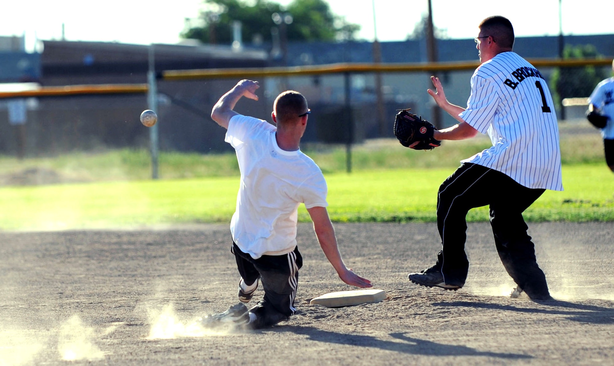 MOUNTAIN HOME AIR FORCE BASE, Idaho -- Brett Reynolds, 366th Operations Support Squadron right fielder, slides into second base while Brandon Brockhouse, 366th Maintenance Operations Squadron second baseman, waits for the ball during the OSS versus MOS intramural softball game June 24. OSS won 17-7. (U.S. Air Force photo/Senior Airman Samantha S. Crane)