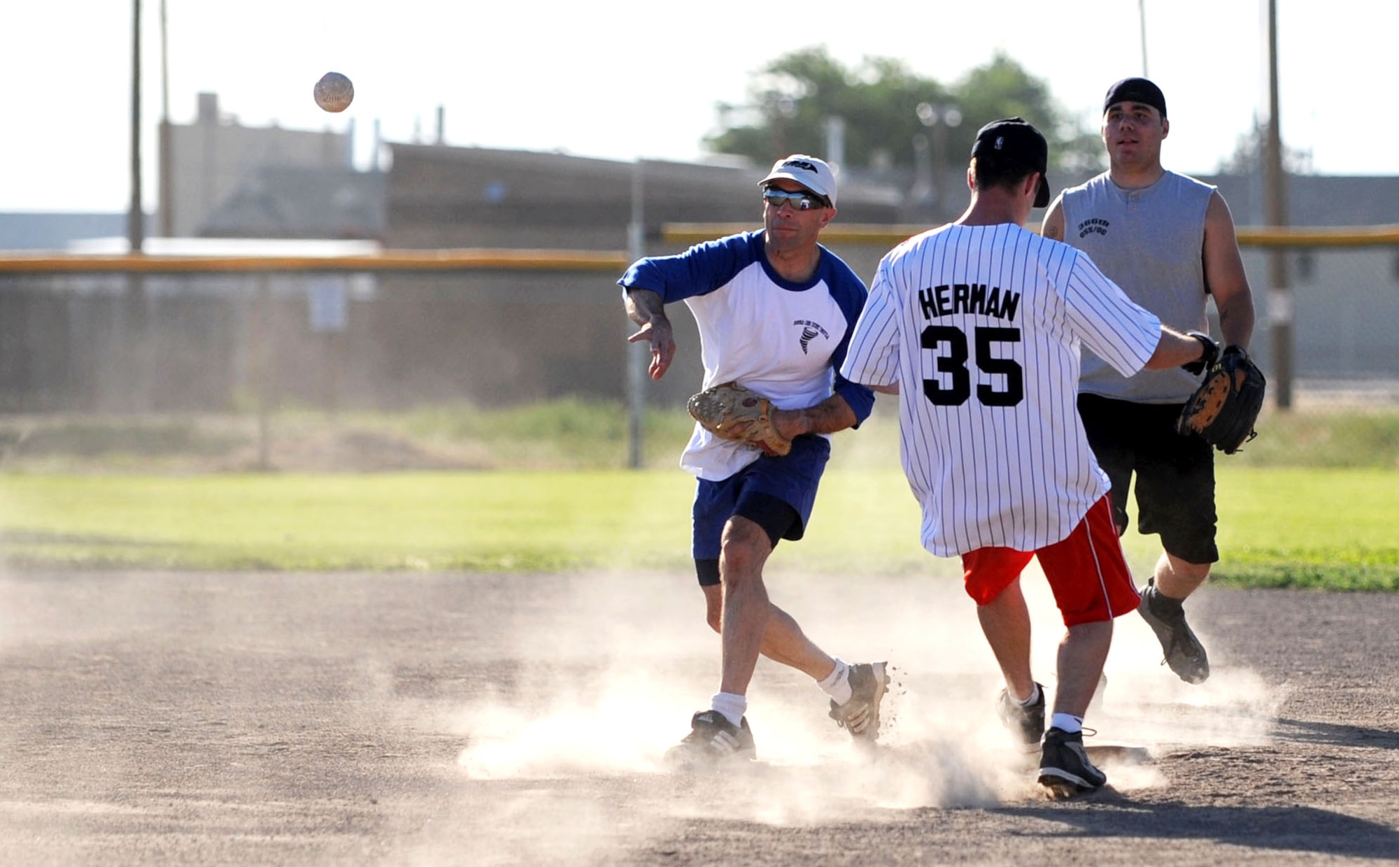 MOUNTAIN HOME AIR FORCE BASE, Idaho -- Mark Thompson, 366th Operations Support Squadron second baseman, throws to first base for a double play during the OSS versus 366th Maintenance Operations Squadron intramural softball game June 24. OSS smashed MOS 17-7. (U.S. Air Force photo/Senior Airman Samantha S. Crane)