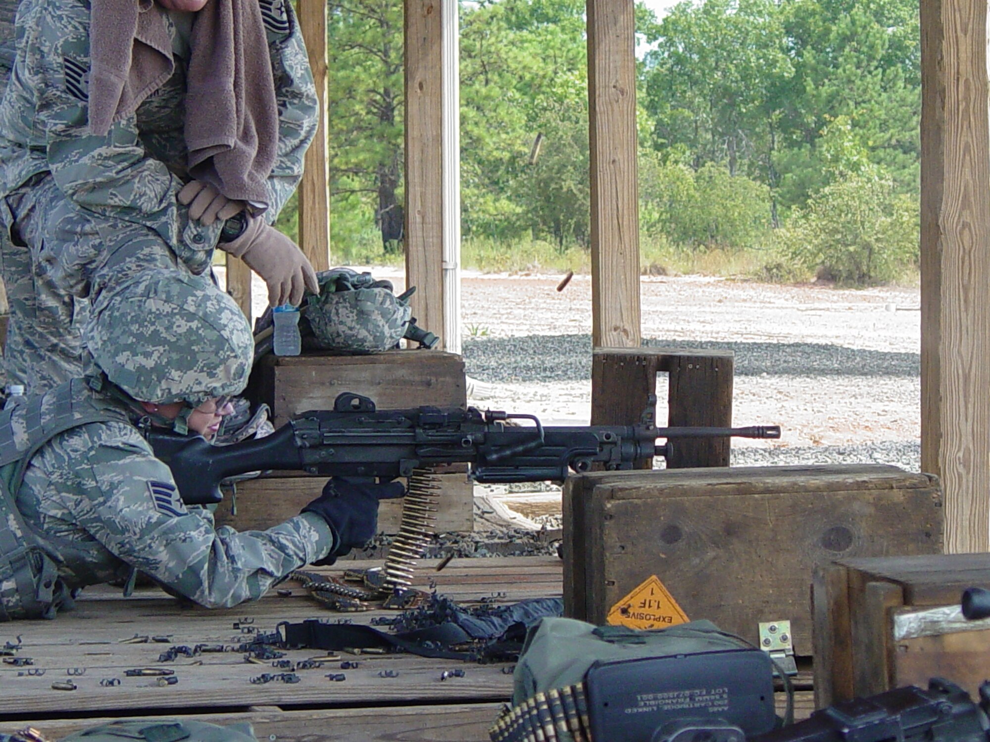 A member of the 437th Security Forces Squadron Combat Arms Section, Charleston Air Force Base, S.C., trains Staff Sergeant Rachel Jones, 315th Security Forces Squadron, Charleston AFB, S.C., on the M249 and M240 light machine gun at Fort Jackson in Columbia, S.C., over the June UTA weekend.   (Air Force photo / TSgt Steven G. Smith)