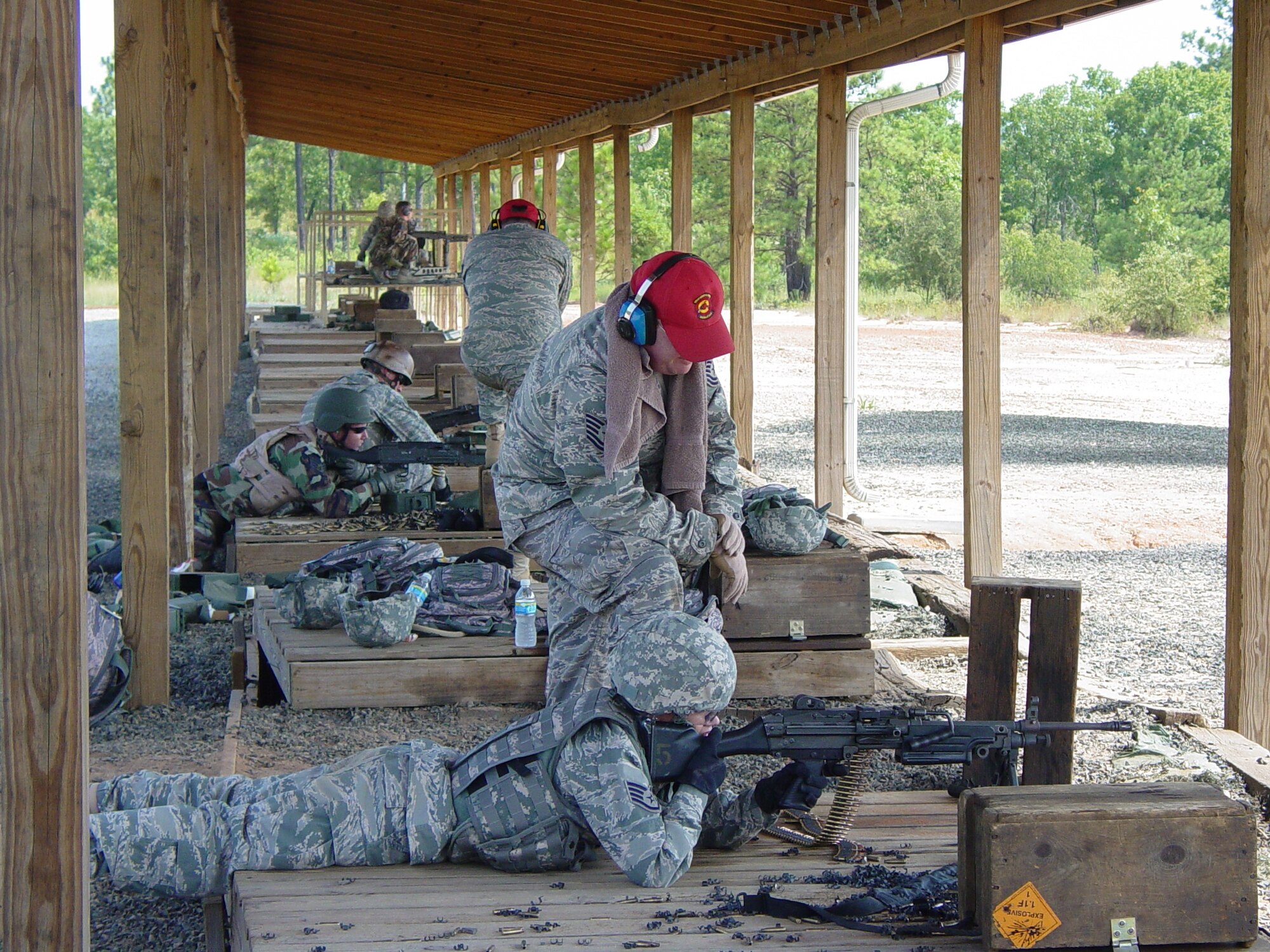 A member of the 437th Security Forces Squadron Combat Arms Section, Charleston Air Force Base, S.C., trains Staff Sergeant Rachel Jones, 315th Security Forces Squadron, Charleston AFB, S.C., on the M249 and M240 light machine gun at Fort Jackson in Columbia, S.C., over the June UTA weekend.   (Air Force photo / TSgt Steven G. Smith)