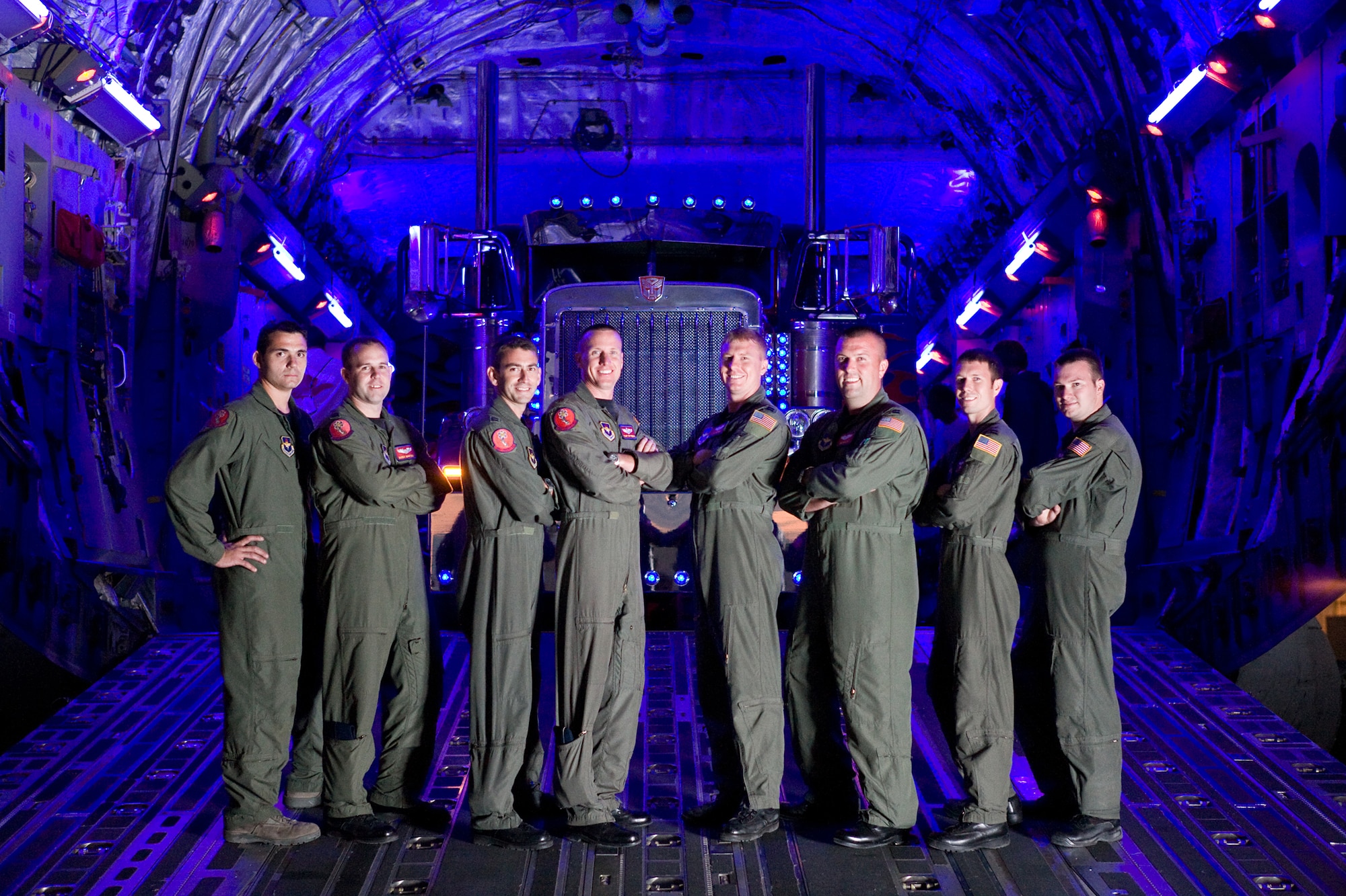 ALTUS AIR FORCE BASE, Okla. -- Aircrews from Altus stand in front of "Optimus Prime" during filming of "Transformers: Revenge of the Fallen." The Airmen and C-17 Globemaster III aircraft were featured in the film. (Courtesy photo, copyright 2009 Paramount Pictures)