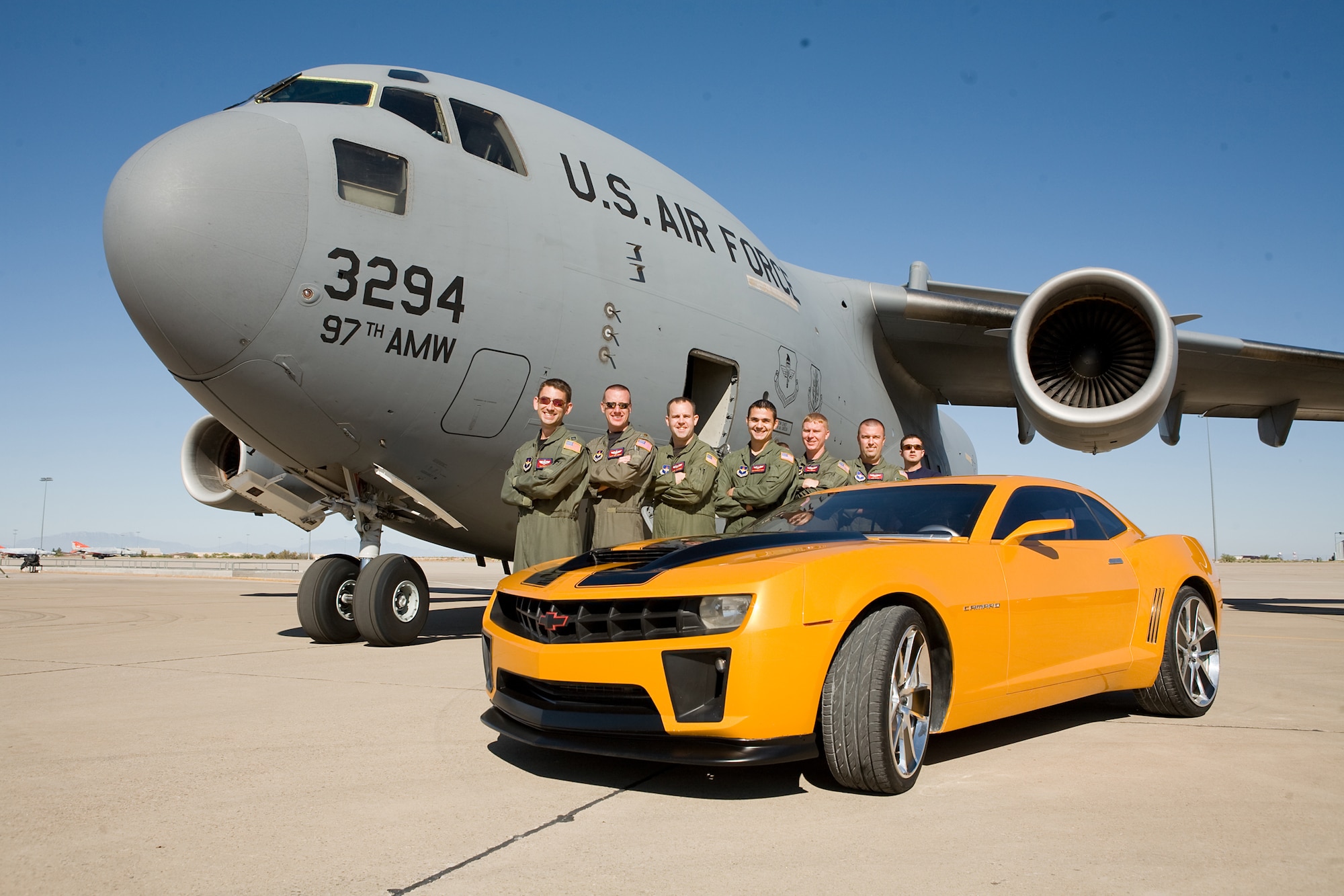 ALTUS AIR FORCE BASE, Okla. -- Aircrews from the 97th Air Mobility Wing pose next to the car used during filming of "Transformers: Revenge of the Fallen." The Airmen were extras in the movie and lent their military expertise to production crews. (Courtesy photo, copyright 2009 Paramount Pictures)
