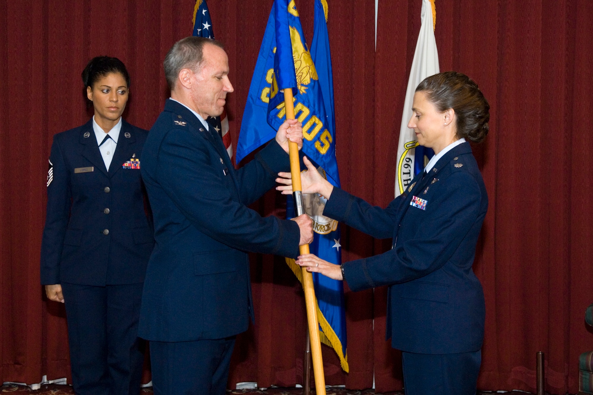 HANSCOM AIR FORCE BASE, Mass. –Col. Parker Plante, 66th Medical Group commander, passes the flag of command to Lt. Col. Melissa Wells. Colonel Wells assumed command of the 66th Medical Operation Squadron during a June 23 ceremony at the Minuteman Club. (U.S. Air Force photo by Rick Berry)
