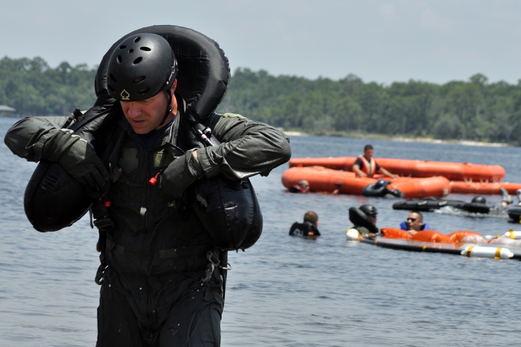 EGLIN AIR FORCE BASE, Fla. -- Lt. Col. Todd Miller, Headquarters Air Force Material Command, takes off his gear after completing raft living procedures during a Survival Evasion Resistance Escape training exercise for pilots June 26 at Post’l Point. The training was a water continuation course which included a parachute drag, smoke flare procedures and recovery hoist training. Pilots must undergo continuation training every three years. (U.S. Air Force photo/ Airman Anthony Jennings)