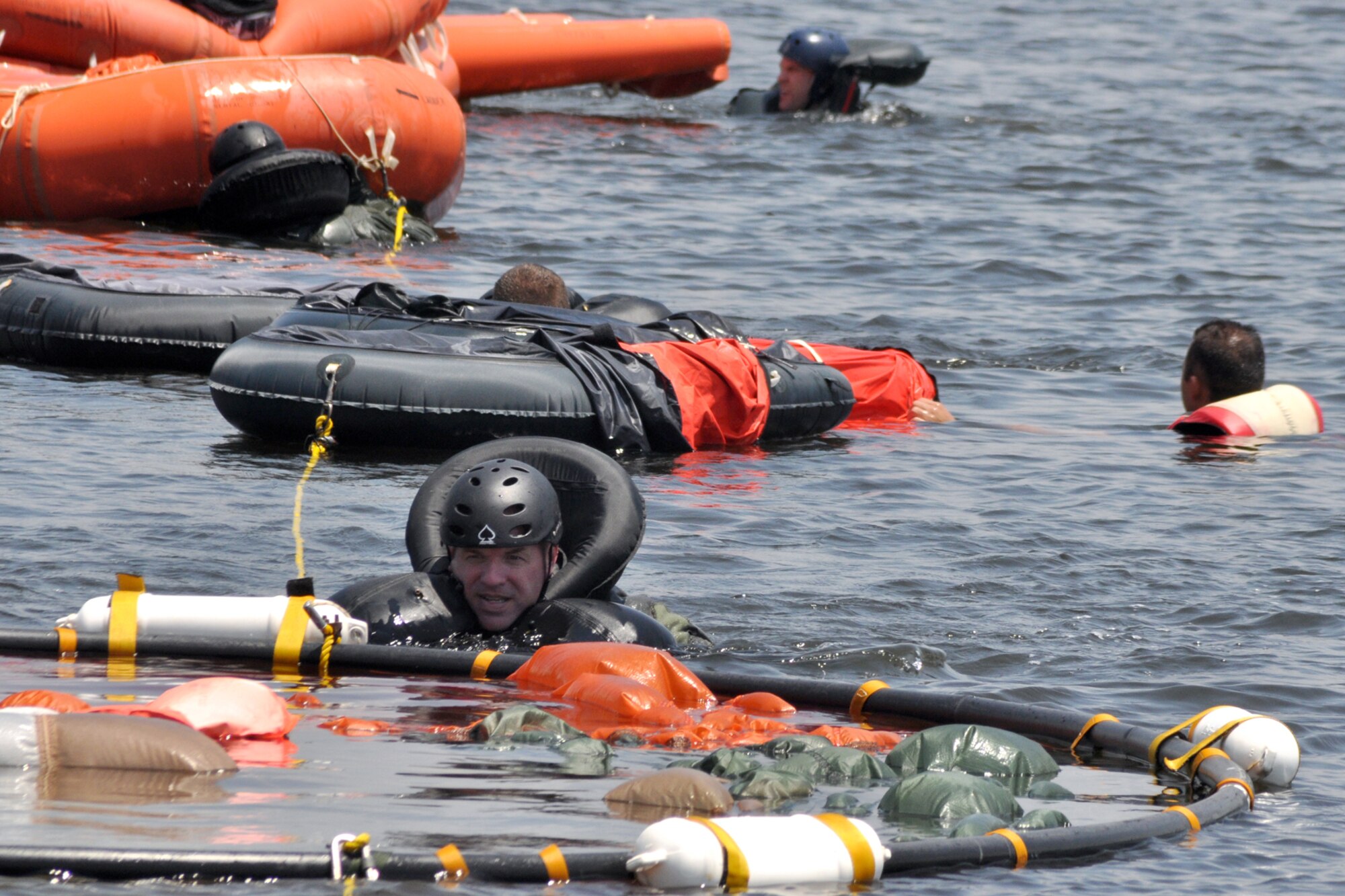 EGLIN AIR FORCE BASE, Fla. -- Lt. Col. Todd Miller, Headquarters Air Force Material Command, undergoes raft living procedures during a Survival Evasion Resistance Escape training exercise for pilots June 26 at Post’l Point. The training was a water continuation course which included a parachute drag, smoke flare procedures and recovery hoist training. Pilots must undergo continuation training every three years. (U.S. Air Force photo/ Airman Anthony Jennings)