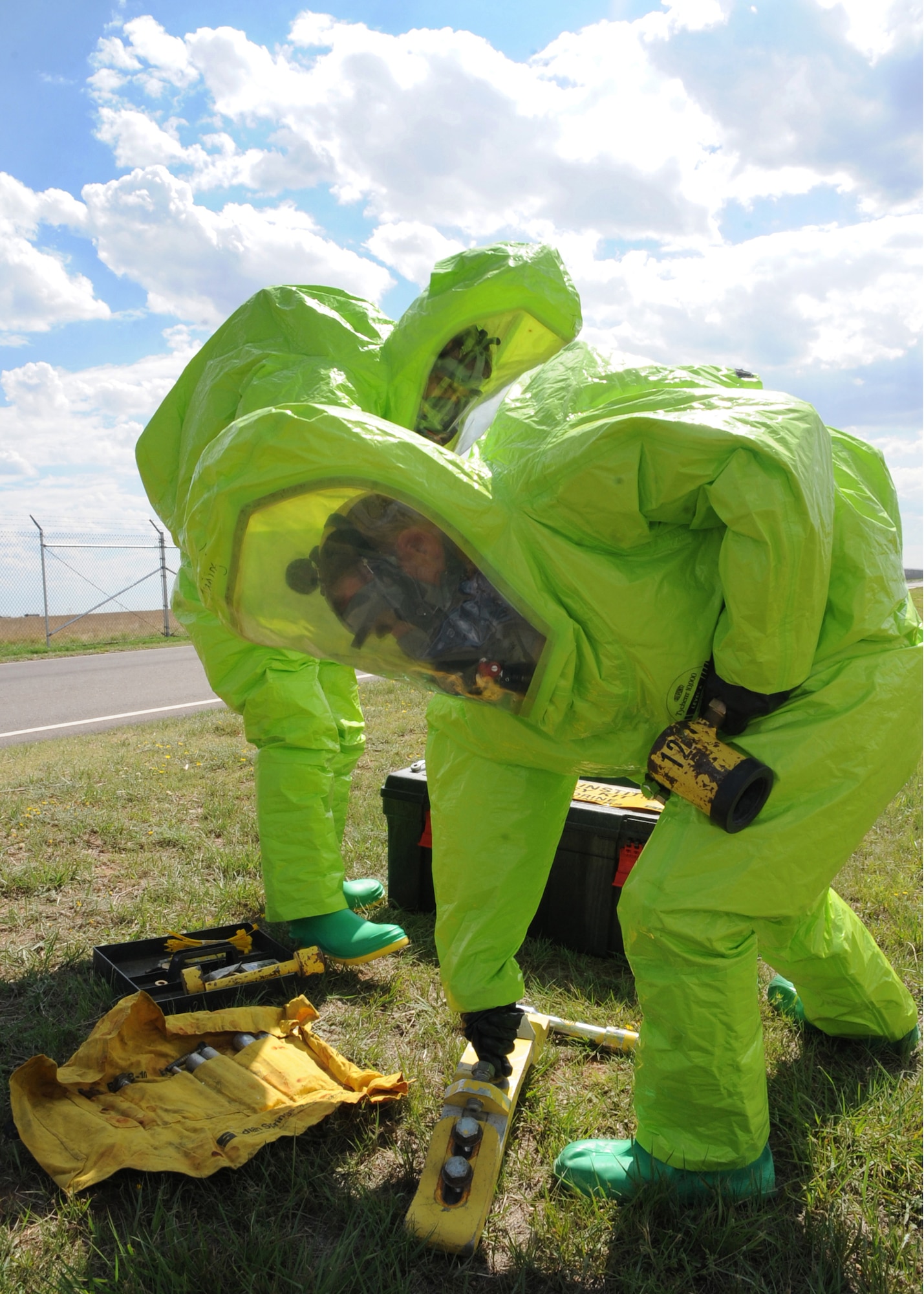 CANNON AIR FORCE BASE, N.M.-- Christopher Chambers (right) and Daniel Cota, 27th Special Operations Civil Engineer Squadron, use a Chlorine B Kit to contain a simulated chlorine leak June 22 during an exercise as part of the Unit Compliance Inspection. The exercise provides training to respond to real world events. (U.S. Air Force photo by Airman 1st Class Maynelinne De La Cruz)