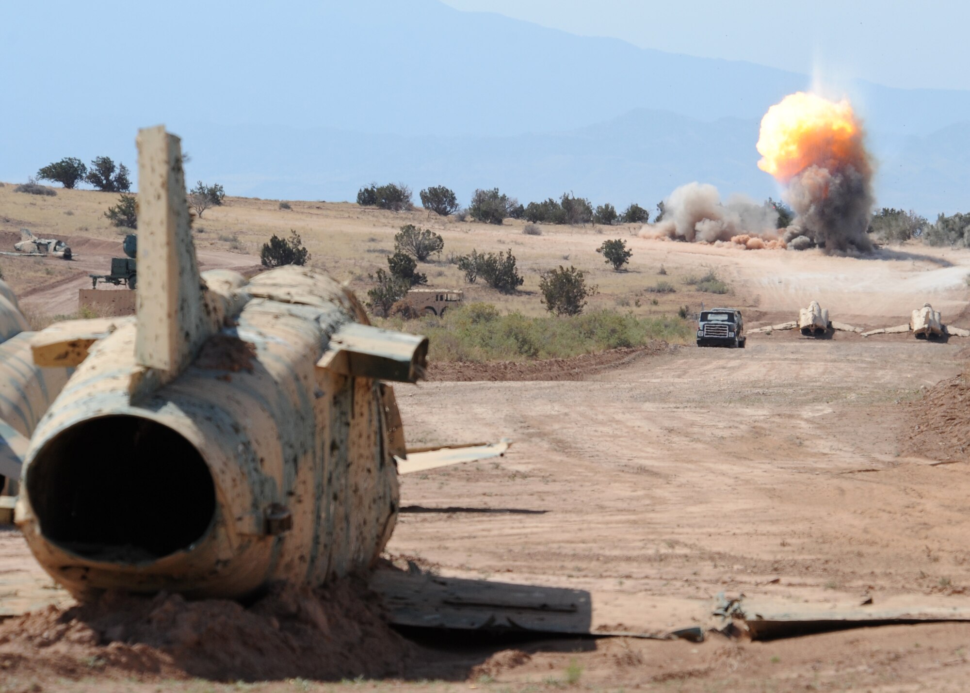 Airmen with the 49th Civil Engineer Squadron explosive ordnance disposal team Holloman Air Force Base, N.M., conduct a controlled detonation June 5. Members of Team Holloman are working together to clear old ordnance and munitions at Red Rio Bombing Range throughout the month of June. The Red Rio Bombing Range is an active Air Force facility that encompasses approximately 196,000 acres on White Sands Missile Range. (U.S. Air Force photo/Senior Airman Michael Means)