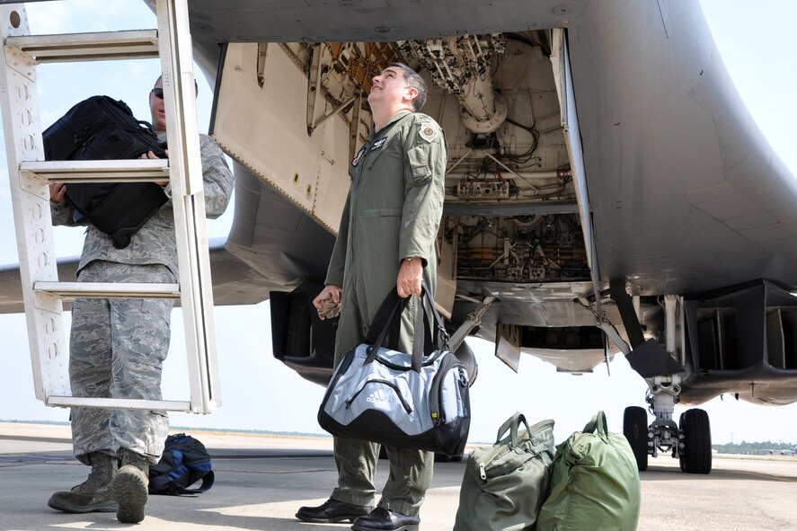 EGLIN AIR FORCE BASE, Fla. – Staff Sgt. Matthew Penrod, 337th Test and Evaluation Squadron, Dyess AFB, Texas., and Col. Mick Guthals, 53rd Wing vice commander, load luggage onto a B-1B Lancer before its flight back home.  The B-1 was here representing the 337th TES for the assumption-of-command ceremony for the 53rd Wing. It is a long-range multi-role, heavy bomber capable of speeds of more than 900 mph. Its wingspan fully extended is 137 feet and can fly intercontinental unrefueled. (U.S. Air Force photo/ Airman Anthony Jennings)