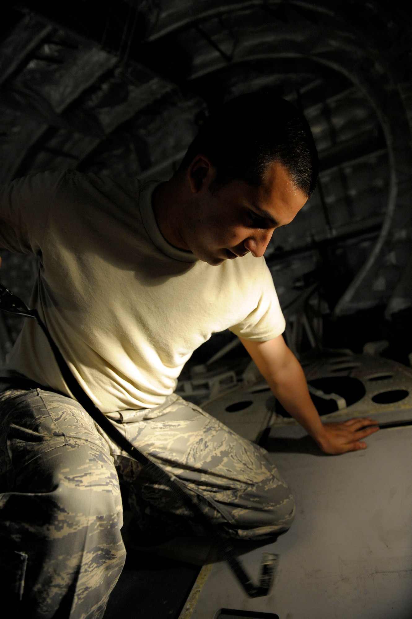 ELMENDORF AIR FORCE BASE, Alaska -- Airman 1st Class Manuel Padilla reinstalls new Velcro on the back floor of a C-17 Globemaster III. Padilla is part of an 11-man crew that is preparing for the Air Mobility Command Rodeo at McChord Air Force Base, Wash., July 18-26. (U.S. Air Force photo/Master Sgt. Keith Brown)