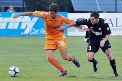 Scott Buete with the Charleston Battery, right, tries to get past Domenic Mediate with the Puerto Rico Islanders, left, to gain control of the ball during the game at Blackbaud Stadium June 25. This is the third game between the two United Soccer League division-one teams within the last week. The Charleston Battery shut out the Puerto Rico Islanders 1-0 to take first place in USL-1. (U.S. Air Force photo/Staff Sgt. Marie Cassetty)(RELEASED)