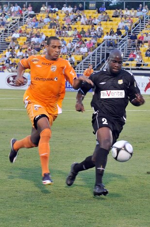Nelson Akwari with the Charleston Battery, right, defends the ball against Nicholas Addlery of the Puerto Rico Islanders, left, during the game at Blackbaud Stadium June 25. An estimated 5,000 people attended the game as the Charleston Battery took on the Puerto Rico Islanders during a nationally televised game on the Fox Soccer channel.  The Charleston Battery shut out the Puerto Rico Islanders 1-0 to take first place in USL-1. (U.S. Air Force photo/Staff Sgt. Marie Cassetty)(RELEASED)