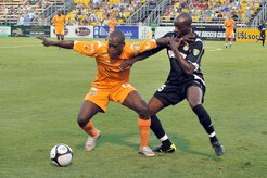 Fabrice Noel with the Puerto Rico Islanders, left, keeps John Wilson with the Charleston Battery, right, from gaining control of the ball during the soccer game at Blackbaud Stadium June 25. This is the third game between the two United Soccer League division-one teams within the last week. The Charleston Battery shut out the Puerto Rico Islanders 1-0 to take first place in USL-1. (U.S. Air Force photo/Staff Sgt. Marie Cassetty)(RELEASED)