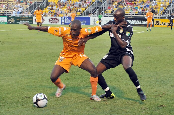 Fabrice Noel with the Puerto Rico Islanders, left, keeps John Wilson with the Charleston Battery, right, from gaining control of the ball during the soccer game at Blackbaud Stadium June 25. This is the third game between the two United Soccer League division-one teams within the last week. The Charleston Battery shut out the Puerto Rico Islanders 1-0 to take first place in USL-1. (U.S. Air Force photo/Staff Sgt. Marie Cassetty)(RELEASED)