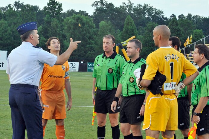 Col. Donald Shaffer flips the coin as the referees and team captains watch marking the start of the Charleston Battery soccer game held at Blackbaud Stadium June 25. The Charleston Battery took on the Puerto Rico Islanders during a nationally televised game.  Colonel Shaffer is the 437th Airlift Wing vice commander. (U.S. Air Force photo/Staff Sgt. Marie Cassetty)RELEASED)