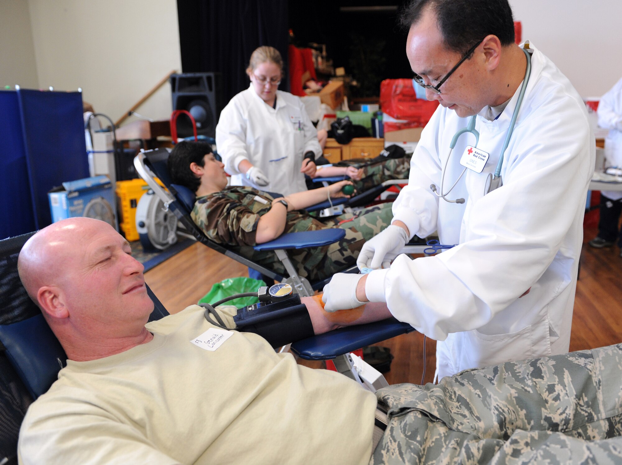 MOUNTAIN HOME AIR FORCE BASE, Idaho - Master Sgt. Gerald Lancaster, 366th Logistics Readiness Squadron vehicle operator, donates blood as Griselda Vasquez, American Red Cross phlebotomist, monitors his blood flow at a blood drive at the Community Center June 24. Eighty percent of the blood donations given to the Red Cross are collected at mobile blood drives set up at community organizations, companies, high schools, colleges, places of worship or military installations. The American Red Cross works with more than 50,000 sponsors each year to hold more than 120,000 blood drives, providing convenient locations for people to give blood. (U.S. Air Force photo\Staff Sgt. Megan Lyon)