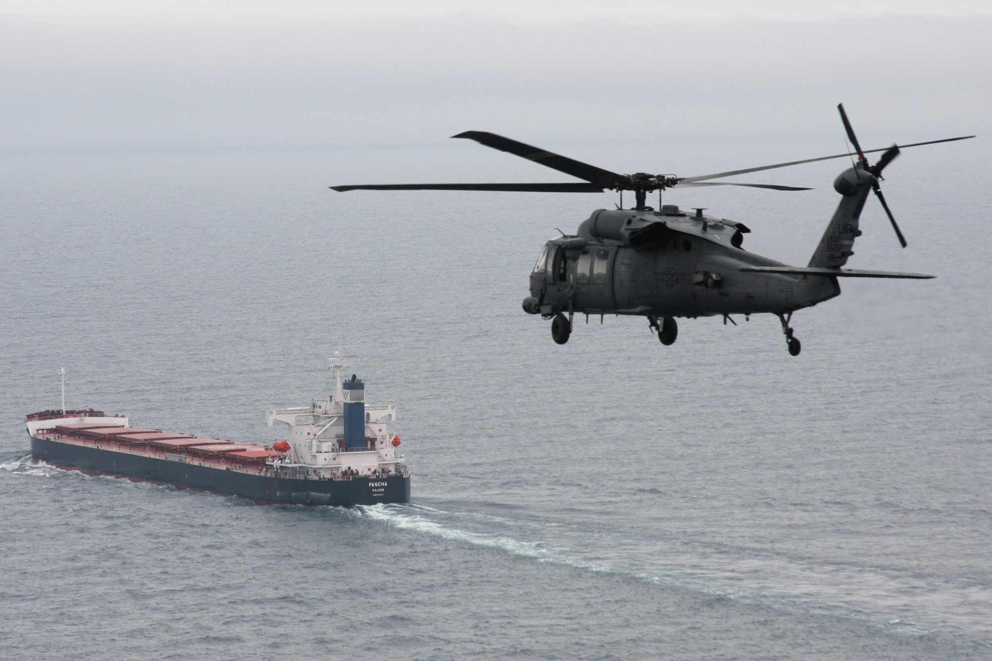 A 56th Rescue Squadron HH-60G Pave Hawk from Royal Air Force Lakenheath, England, flies toward the cargo ship Pascha approximately 400 miles off of the west coast of Ireland June 26. Two helicopters from the squadron made the journey to save a sailor who was experiencing severe abdominal pain and required immediate medical evacuation. Two additional U.S. Air Force aircraft, a KC-135 Stratotanker from the 100th Air Refueling Wing and a MC-130P Combat Shadow from the 352nd Special Operations Group, both from RAF Mildenhall, England, supported the operation for refueling and communication purposes. A Nimrod, search and rescue aircraft, from the United Kingdom also played a critical role in the operation, providing real time communication and coordination between the ship and aircraft. The patient was delivered to an awaiting ambulance in Shannon, Ireland, and is in stable condition. (U.S. Air Force photo/Master Sgt. Jay Reinschi) 

