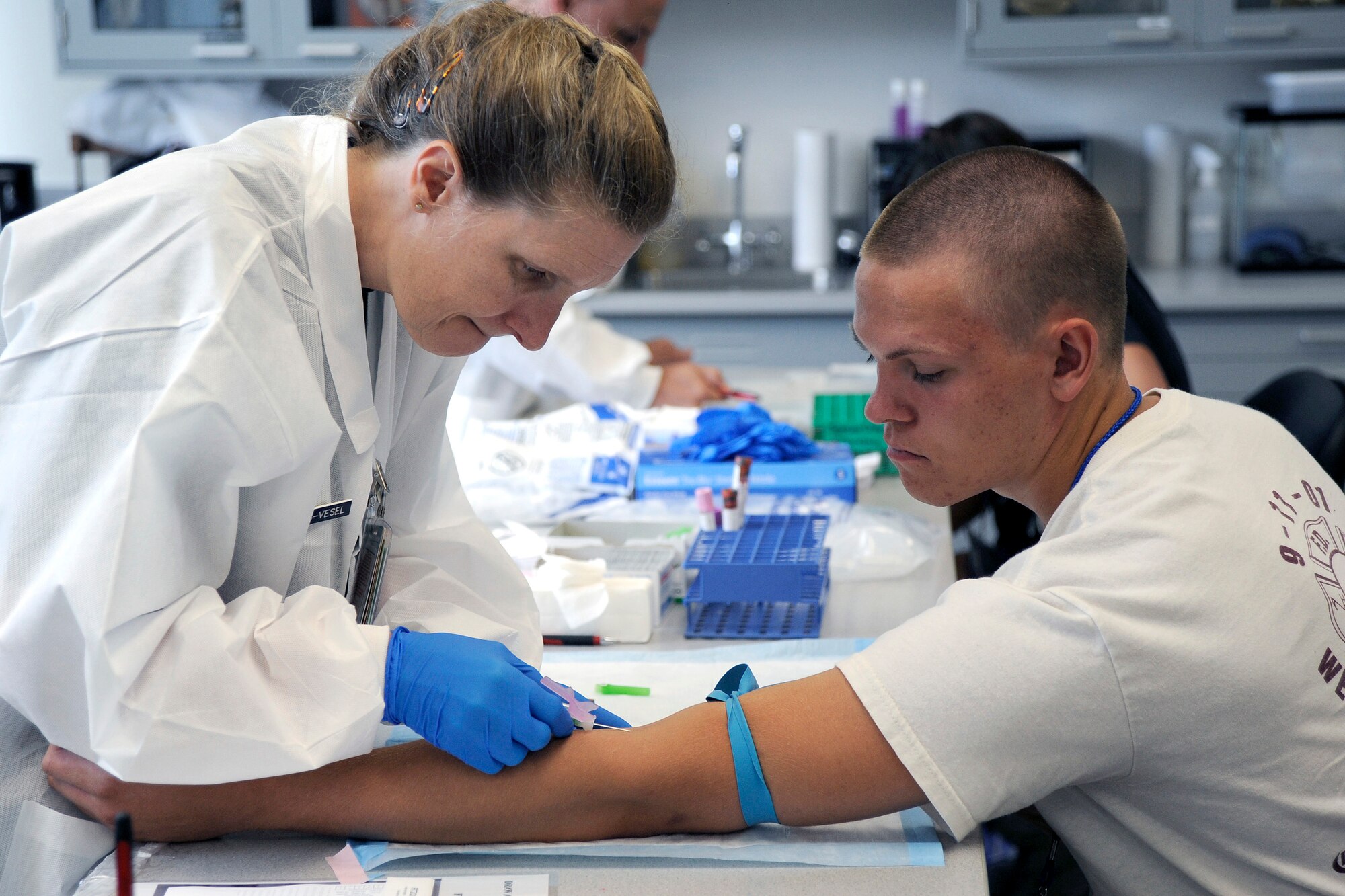 Col. (Dr.) Jane Hendricks-Vesel draws blood from a basic cadet during Class of 2013 inprocessing at the U.S. Air Force Academy in Colorado Springs, Colo. Cadets must pass physical exams administered by the Department of Defense Medical Examination Review Board, a tenant unit at the Academy that schedules, evaluates and certifies applicants for all U.S. service academies, ROTC scholarship programs and direct commissioning programs. (U.S. Air Force photo/Dave Ahlschwede)