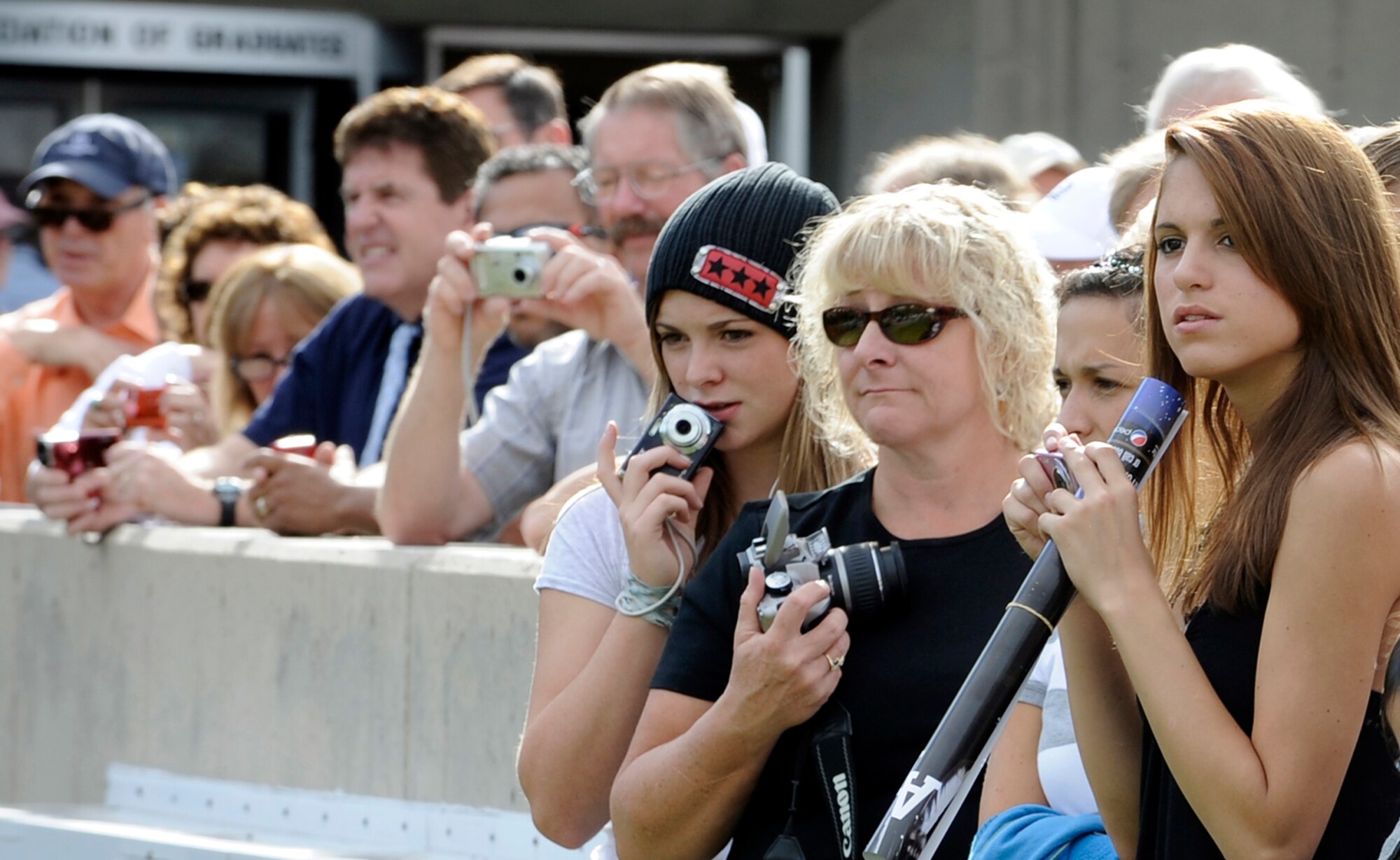 Family members catch glimpses of their basic cadets outside Doolittle Hall at the U.S. Air Force Academy in Colorado Springs, Colo., June 25. The Class of 2013 consists of more than 1,300 basic cadets from locations across the United States as well as 11 international cadets. (U.S. Air Force photo/Dave Ahlschwede)